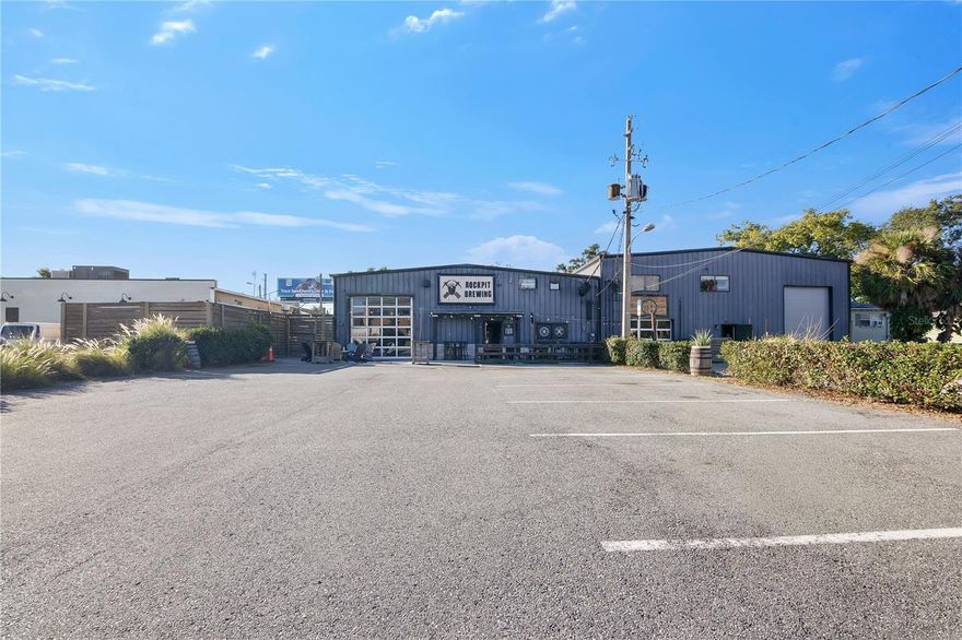 Rare opportunity to acquire a two-building industrial asset totaling approximately 11,171 SF across two contiguous parcels in the heart of Orlando’s highly sought-after SoDo district. The property is fully leased to a long-term tenant operating as Rockpit Brewing, a well-established local brewery and taproom that has occupied the space since 2019. Current rent is $11,655/month on a modified gross lease through December 2026. The tenant has invested more than $150,000 in brewery-specific improvements, including a custom walk-in industrial freezer and on-site production infrastructure, creating long-term occupancy stability and a high likelihood of renewal. The property features a new roof and HVAC system (installed within the past year). Zoned ORL-AC-2/SP, the site supports a wide range of commercial and industrial uses. Located minutes from Downtown Orlando and the Orlando Health medical campus, the property benefits from strong area demographics, consistent foot traffic, and continued submarket rent growth.