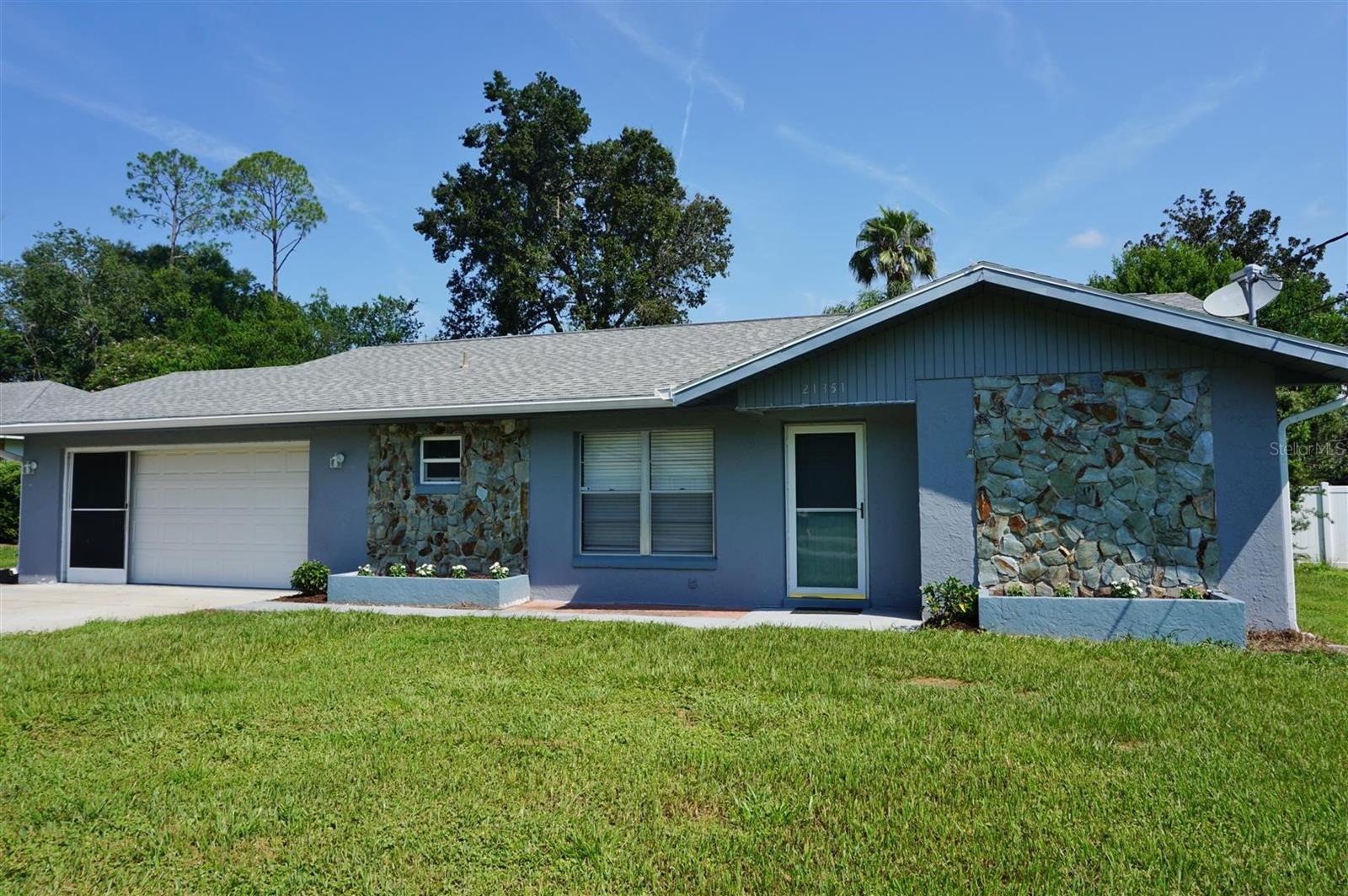 POOL HOME IN RAINBOW LAKES ESTATES! This completely updated home is ready for you to move right in. Step inside to the spacious open floor plan that features a great room with fireplace, lovely kitchen with granite counters, breakfast bar, SS appliances and modern cabinetry and dining area. French doors lead to the sparkling caged pool and a covered area for relaxing and dining. The master suite has a walk-in closet and private bath with a beautifully appointed walk-in shower. Bedroom 2 and 3 are split by the hall bath with a tub/shower combo. The large laundry room has plenty of space for storage. Imagine entertaining poolside, relaxing and dining. Just outside the pool cage is a covered patio that would be a great spot for grilling or setting up your karaoke machine and hosting a party in the completely fenced yard. Located close to Rainbow Springs State Park, shopping, dining and more! Come see all this affordable home offers!