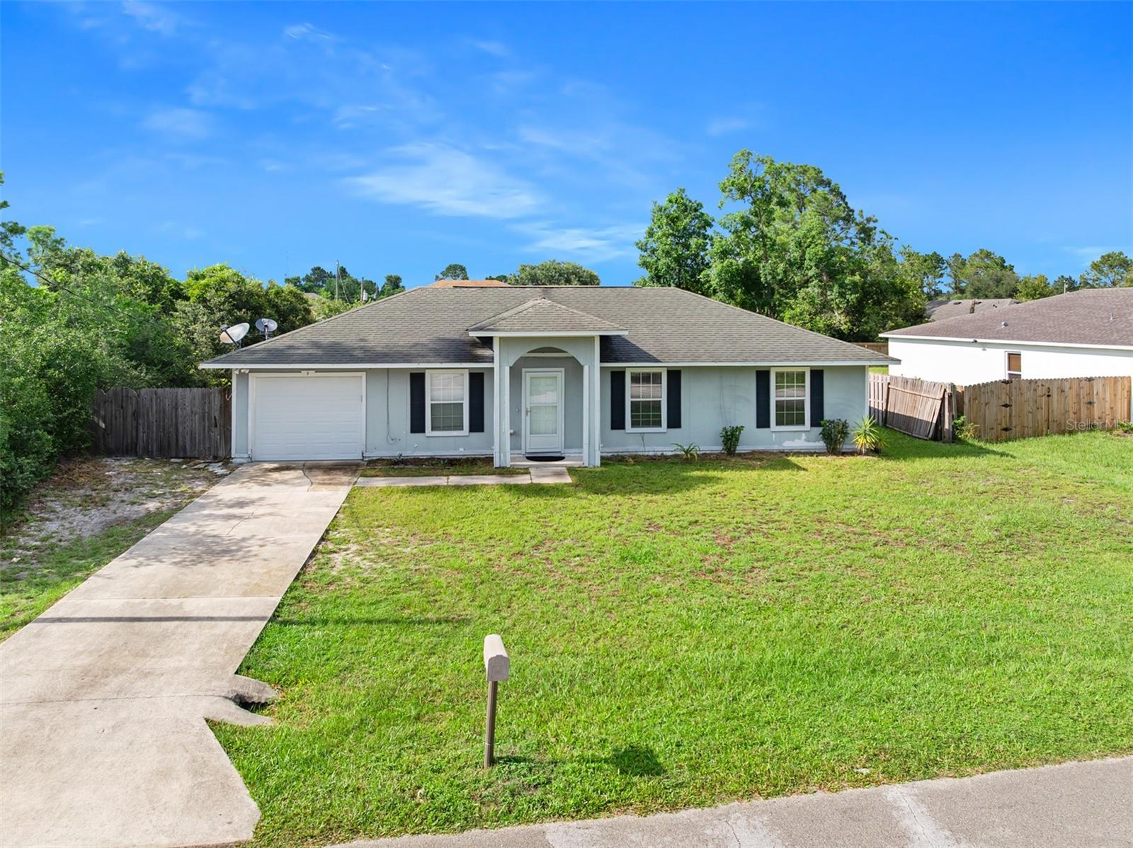 Great starter or home to downsize in located in a convenient location. Located right off of US-1 in the Pine Lakes area, this 2005 built, 3 bedroom, 2 bath home awaits its next owner. The home boasts a great outdoor space with the lot size being .229 of an acre. No carpet throughout the home assists in easier maintenance. An abundance of cabinets adorn the kitchen for all your kitchen storage needs. The inside laundry room features a shelf above and also contains the water heater and air conditioner, keeping the 1-car garage space true garage space. A/C is 2017, water heater is 2023.