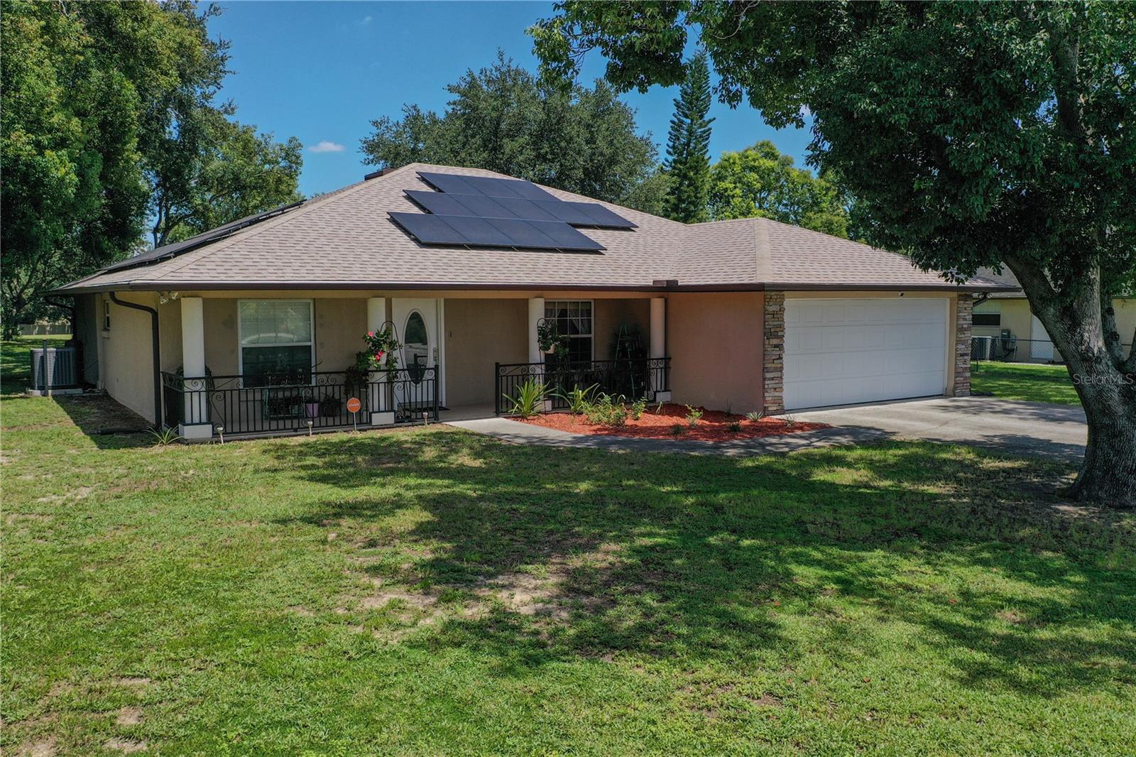 Prepare to be enchanted by this stunning new listing that beautifully blends comfort, luxury, and outdoor living on a sprawling one-acre oasis, free from the constraints of an HOA. This open-concept home boasts three generously sized bedrooms, including an extra-large primary suite that features a lavish two-person shower complete with a rain head showerhead—perfect for unwinding after a long day. The split-bedroom layout ensures privacy, while the laminate flooring throughout, and elegant tile in the bathrooms, creates a seamless flow. Indulge your senses in the guest bath, equipped with a rejuvenating Jacuzzi tub. Step outside into your own paradise, where a screen-enclosed chlorine pool awaits, complemented by a massive 40 x 60 pole barn that offers limitless possibilities for storage or hobbies. Your peace of mind is prioritized with a security alarm system, including five strategically placed cameras, while energy efficiency is enhanced by solar panels, set to be paid off at closing. Enjoy smart living with an array of connected devices, including the thermostat, pool equipment, attic and garage fans, and the garage door opener, all designed to elevate your lifestyle. Additionally, a convenient plug-in for a whole-home generator is available, allowing you to bring your own generator for added peace of mind during outages. With 28 trees, including peach, eucalyptus, oak, and camphor, along with knee-length ginger shampoo plants adding lush greenery, this property is a gardener's dream. Located within walking distance of Discovery High School and Middle School, and with recent upgrades like a new roof (2023), water filtration system (2022), and pool filter and pump replacement this year, this home is a perfect blend of modern comfort and timeless charm. Don't miss out on this gem—view the attachments for a comprehensive list of all recent upgrades, and let this property be the canvas for your new lifestyle!