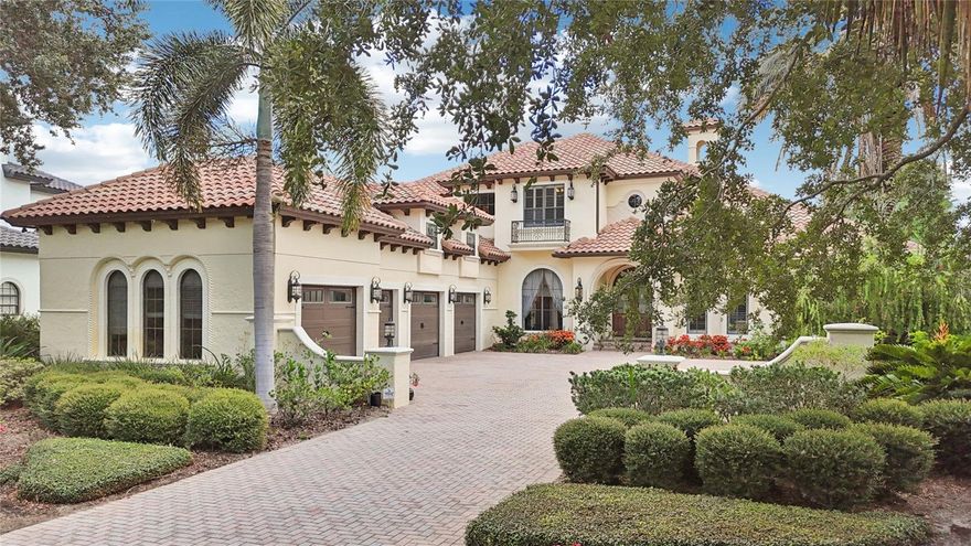 Welcome to 9253 Tibet Pointe Circle in the beautiful 24-hour gated/guarded community of Keene's Pointe in Windermere, Florida.  This elegantly timeless JR Watson custom-built mediterranean style home located on over 224 feet of lake frontage on Lake Tibet of the Butler Chain of Lakes, offers a functional and spacious floor plan to accommodate any buyer.  Entering the drive up to the courtyard is a 4-car garage and inviting entrance with wood and glass arched doors.  The formal living room with gas fireplace and private dining room pave the way to the kitchen with large breakfast bar, island, walk-in pantry and high end appliances, overlooking the great room with wood beamed ceiling and sliding pocket doors, as well as a wet bar, wine cellar and spacious laundry and mud area.  On the other side is the private primary suite with large walk-in closet and spacious primary bath, as well as a functional office with built-ins and wood beamed ceiling.  The second floor boasts a bonus area half way up the wood and iron staircase, perfect as a media or exercise room or additional office or hobby room. At the top of the stairs is an open area with built-in desks for study time, three spacious en-suite bedrooms and a game room with wet bar that opens up to the balcony overlooking the back yard and lake.  Perfect for entertaining the 10 ft. multi slide pocket doors in the family room open up to the lanai to create a seamless transition between indoor and outdoor space to the outdoor lanai large enough for another complete living area with summer kitchen and its own gas fireplace overlooking the pool with rock waterfall and spa.  Just outside the screened enclosure is the fire pit with an abundance of seating, fenced back yard and walk way to the boat dock.  This home boasts 12 ft. ceiling throughout with exquisite architectural details, and has been lovingly attended to with new sod, new pool equipment, smart home features such as Sonos, Lutron lighting, MyQ, smart thermostats, security and camera systems, updated AC units, newer Sub Zero and Wolf appliances, hardwood flooring, plantation shutters, and much more!  Conveniently located to top-rated public and private schools, shopping, dining, expressways and tourist attractions.  This beautiful lakefront estate is priced to sell, call today for your private viewing.