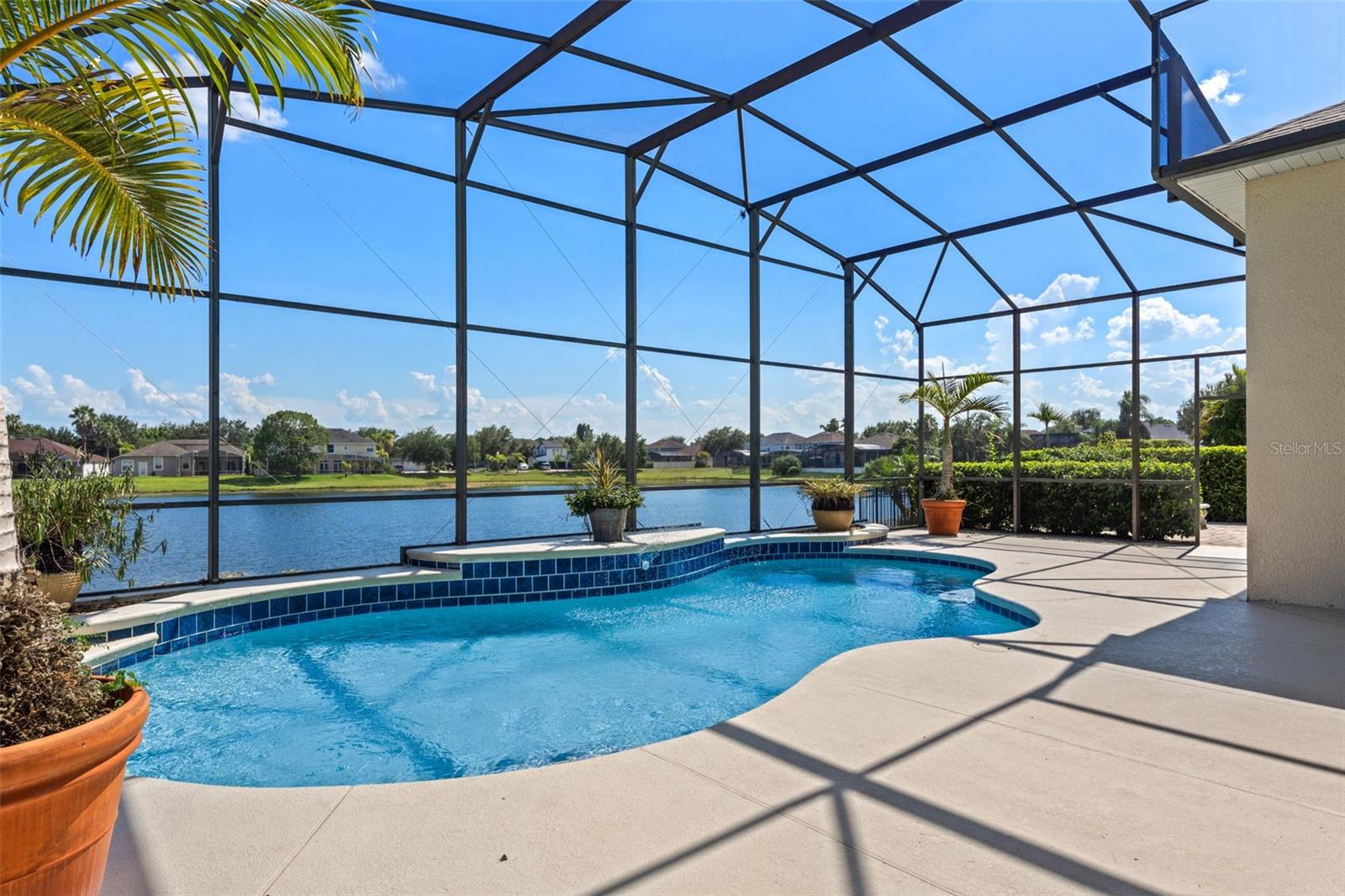 POND FRONT | SINGLE STORY | 3-CAR GARAGE | PAVER DRIVEWAY | HUNTERS CREEK
Located in the Flora Vista neighborhood, this single-story home offers over 2,700 sq ft with 12-foot ceilings and a thoughtfully designed open and bright split floor plan. Freshly painted (2025) with a new roof installed in 2018, the layout includes 4 bedrooms, 3 full bathrooms, and a dedicated front office with double doors. The primary suite provides privacy, set apart from the secondary bedroom wing and full pool bath. The kitchen features a center island, 42" cabinetry, stainless steel appliances, and bar-height seating, opening to a spacious family room with a full window wall and a breakfast nook overlooking the pool and pond. A large covered lanai leads to the screened pool, offering peaceful water views with homes situated across the pond. Interior finishes include tile and engineered wood flooring, built-in closet systems, and an interior laundry room with cabinetry for added storage. Hunters Creek residents enjoy access to community parks, outdoor trails, playgrounds, and athletic courts, with convenient proximity to SR-417, SR-528, Orlando International Airport, The Loop, Downtown Orlando, and area theme parks.
