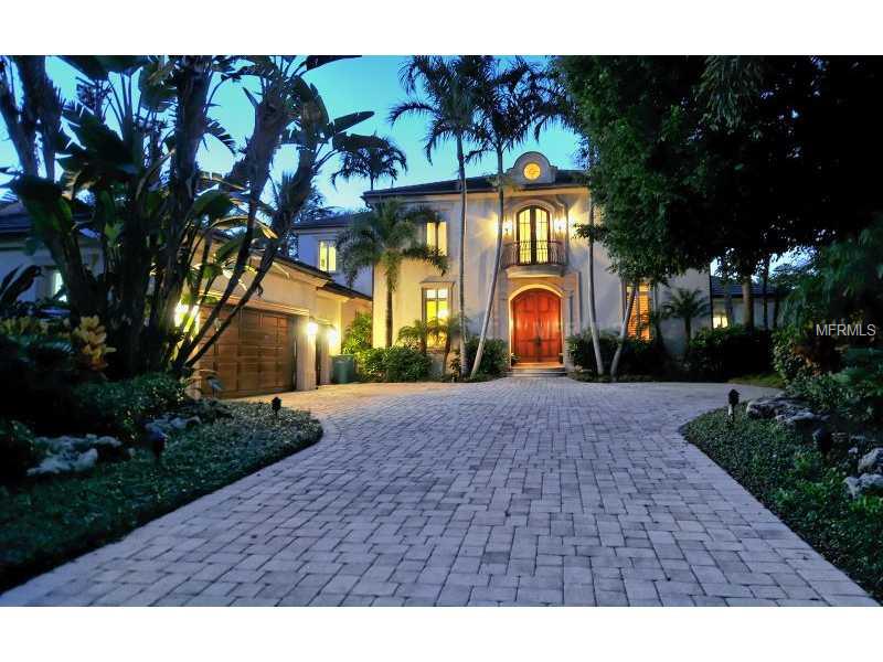 Located behind the gates, Islandside on a private enclave of 16 homes in Lighthouse Point, is this exquisite 5000 sq. foot custom home featuring a spacious open floor plan with a two story living room and views out to the pool, peaceful lagoon and boat dock. The large master first floor suite has sliders that open to the outdoor patio and also the stunning water views. The master suite has his and her closets plus a master bath with exquisite finishes. On the first living level is the chef's kitchen adjoined by a spacious family gathering area that opens to the pool/patio. There is also a first floor office plus a 3 car garage. The upstairs has 3 bedroom suites, two of them with a terrace overlooking the lagoon view. The finishes in this custom home include a stone entry way, warm wood flooring, special cypress ceiling treatments and granite and marble finishes. The outdoor living area is expansive and peaceful. The dock is an added amenity for the boat lover. Owners in Lighthouse Point enjoy their own private tennis court plus they can walk the beach and have the security of living behind two gates.