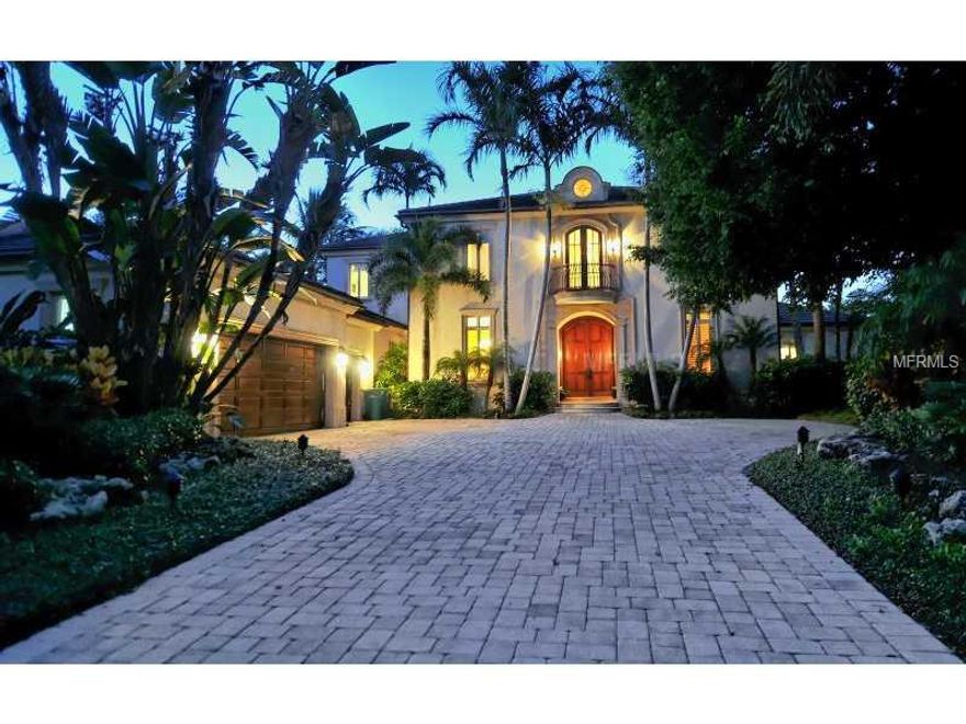 Located behind the gates, Islandside on a private enclave of 16 homes in Lighthouse Point, is this exquisite 5000 sq. foot custom home featuring a spacious open floor plan with a two story living room and views out to the pool, peaceful lagoon and boat dock. The large master first floor suite has sliders that open to the outdoor patio and also the stunning water views. The master suite has his and her closets plus a master bath with exquisite finishes. On the first living level is the chef's kitchen adjoined by a spacious family gathering area that opens to the pool/patio. There is also a first floor office plus a 3 car garage. The upstairs has 3 bedroom suites, two of them with a terrace overlooking the lagoon view. The finishes in this custom home include a stone entry way, warm wood flooring, special cypress ceiling treatments and granite and marble finishes. The outdoor living area is expansive and peaceful. The dock is an added amenity for the boat lover. Owners in Lighthouse Point enjoy their own private tennis court plus they can walk the beach and have the security of living behind two gates.