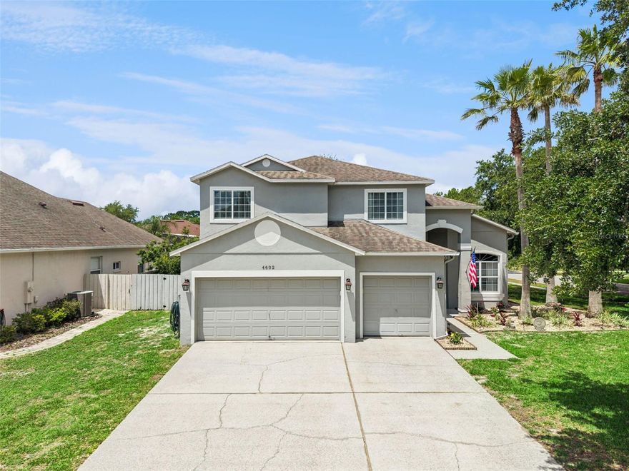 Welcome to one of East Orlando’s hidden gems in the highly sought-after community of Georgia Cove. Tucked near Lake Georgia with immediate access to 417, close to UCF, shopping, dining, and downtown Orlando, this stunning corner-lot pool home combines space, style, and functionality in one unforgettable package. Offering 4 bedrooms, 3 full bathrooms + office/den, and 2,682 square feet of living space, this home also features a spacious 3-car garage and a resort-style heated saltwater pool retreat in the fully fenced backyard. Stepping inside you’re immediately greeted by soaring vaulted ceilings and a dramatic split staircase that creates a grand first impression. The elegant foyer opens to formal living and dining spaces while the staircase uniquely wraps around to provide access from both the front entry and the main living and kitchen areas, adding both beauty and functionality to the layout. The heart of the home is the beautifully updated country-chic kitchen featuring granite countertops, decorative tile backsplash, stainless steel appliances, a double oven range, upgraded cabinetry, and an extended butcher block island perfect for gathering and entertaining. Above the microwave, a custom wood hood-style feature adds warmth and charm, while the oversized walk-in pantry with a swing door and decorative chicken wire detail delivers character rarely found in homes. Downstairs also includes a private office/den with French doors conveniently located next to a full bathroom, making it an ideal setup for guests, multi-generational living, or a potential fifth bedroom option. Throughout the home, thoughtful design details create warmth and personality, including wood accents around windows, custom barn doors, and inviting living spaces filled with natural light. Upstairs features luxury vinyl plank flooring throughout and leads to four spacious bedrooms, including an incredible primary suite overlooking the backyard oasis. The primary bedroom showcases a beautiful wood accent wall, dual oversized walk-in closets, and French doors with enclosed blinds opening to a private covered balcony complete with roll-down privacy shades. A dedicated brand new mini-split system was added to the primary suite for those who prefer an extra-cool sleeping environment. The fully renovated primary bathroom feels like a spa retreat with a frameless glass shower enclosure, decorative tilework, oversized niche, freestanding soaking tub beneath a chandelier, and upgraded vanities, mirrors, fixtures, and hardware throughout. Additional upstairs bedrooms share an updated secondary bathroom featuring modern tile, black hardware accents, updated vanity, mirror, and lighting. Step outside through the rear sliders to your private backyard retreat featuring a heated saltwater pool with sun shelf, beautiful rock landscaping, a fire pit gathering area with string lighting, a storage shed, and plenty of green space to enjoy. The fully wood-fenced backyard creates the perfect setting for entertaining, relaxing, or enjoying Florida evenings year-round. Major updates include a brand-new water heater (2026), AC system (2022), and a BRAND NEW ROOF to be installed prior to closing, offering peace of mind for years to come. Other updates throughout include an updated irrigation system, hanging rack storage in the garage, and a smart deadbolt on the front door. Homes in Georgia Cove rarely hit the market, make an appointment to see it today!