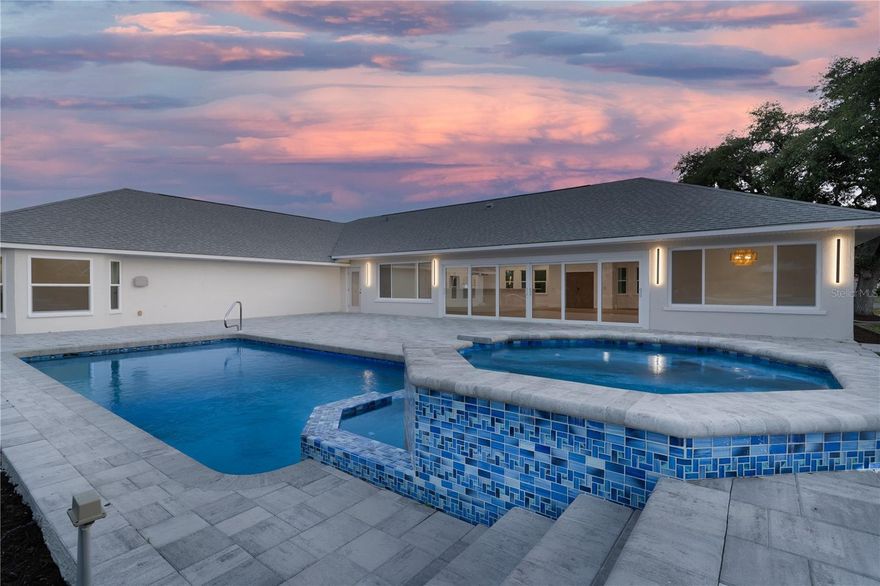 The Entertainer's Dream Home, featuring a lavish heated POOL & SPA.  Your massive lanai is able to accommodate 15-20 guests with ease, as even more gather on the home's private canal-side dock.  Inside, your kitchen blends rare sophistication with function: HIDDEN WALK IN PANTRY - complete with a discreet "COSTCO DOOR", so you can transport your groceries - from garage to pantry instantly.  Your hidden walk in pantry also features a mini fridge and separate wine fridge.  Never run out of space in your kitchen with endless cabinets.  This home truly has an abundance of space and storage.  The Kitchen Bar Counter is able to seat 10+ guests, while more guests can enjoy and gather in the Breakfast nook or Formal Dining Area.  The home carries an impressive five bedrooms, with four En-Suite retreats, offering refined comfort and privacy.  A spacious 1/2 bath is also available for your guests.  Truly, there is no shortage of space and living area - even your backyard is expansive due to the generous land size of nearly an acre.  The home sits high and dry, no flood insurance needed.  Additionally, the home features Hurricane Impact Windows and doors throughout, tankless water heater, fully paid off solar panels and an expansive 3 car garage.  A 12 minute drive to Englewood Beach makes this an exceptional opportunity to own a luxury residence of this caliber in Englewood's most coveted settings.  Welcome to Rosewood Dr - A Home Where You Can Truly Have It All.