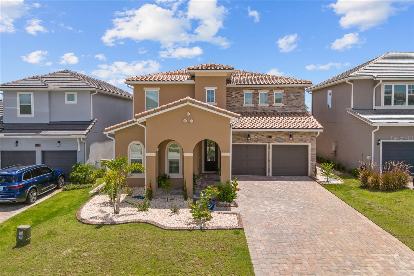 THE GOLF CLUB LIFE IS CALLING YOU!!! Live the Luxury Golf Lifestyle at Bella Collina – Welcome to your opportunity to live and play on the prestigious private golf course of Bella Collina! This exceptional 5-bedroom, 4-bathroom residence—built in 2024—offers the perfect blend of luxury, comfort, and functionality. Situated in Central Florida's premier guard-gated, lakefront, and golf course community, this Captiva model is move-in ready and filled with designer upgrades.? Home Highlights: Spacious open-concept floor plan ideal for entertaining and everyday living. Primary suite + second bedroom/office on the main floor – perfect for multigenerational living or a work-from-home setup. Gourmet kitchen featuring cooktop, single wall oven, microwave trim kit, stainless steel canopy hood, soft-close cabinetry, and decorative glass pantry door. Outdoor kitchen for seamless indoor/outdoor entertaining. Custom brick accent walls in living room and foyer. Stylish open iron staircase railings and loft space upstairs. Luxury bathroom with rainfall shower in the primary suite and upstairs walk-in tile shower with swinging glass door. Laundry room with cabinets and built-in sink. Epoxy-coated garage floor (gray with speckle finish). Glass front door, recently installed for extra curb appeal. Backyard upgrades: fully fenced, stone edging, and side pavers. Pre-wired (30A) for pool heater or hot tub. Bella Collina Lifestyle: Enjoy exclusive access to over 1,900 acres of scenic, private luxury including:75,000 sq. ft. Tuscan-inspired clubhouse, Sir Nick Faldo-designed championship golf course350-acre private, spring-fed lake. Resort-style pool with lap lanes and poolside service. Full-service spa and salon. Har-Tru tennis courts, Sportivo fitness center, and walking trails. Multiple on-site dining options and an elegant event/ballroom venue. Don't miss your chance to own this stunning, nearly new home in one of Florida's most sought-after luxury communities.?? Call today to schedule your private tour and start living the Bella Collina lifestyle!!!