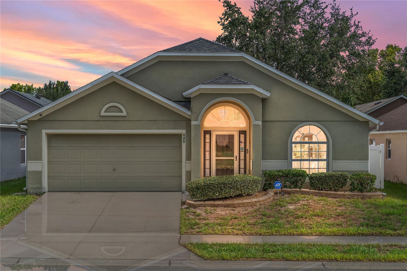 From the moment you walk in, this home feels easy to live in and the layout just makes sense. High ceilings, lots of natural light and wood flooring welcome you into the living room and dining space that gives you options — a spot to host holidays, a quiet sitting area, or even a home office if that’s what you need. Head toward the back and the space really opens up: a big, airy kitchen with a prep island and breakfast bar flows right into the family room, so cooking, chatting, and hanging out all happen in one place. The primary bedroom is tucked off on its own for a little privacy, complete with a walk-in closet and large bathroom. Two more bedrooms and a hall bath sit near the front of the home, giving everyone their own space to spread out. A laundry room right off the garage makes daily life simpler, and out back, a fenced yard with a patio is ready for weekend grilling or letting the dog run. Tucked in Blue Springs Villas, a laid-back community that keeps things simple and welcoming. Everyday errands, dining, and I-4 are just minutes away, making it easy to get to both Orlando and Daytona when you need to. On weekends, you’ve got Blue Spring State Park practically in your backyard — the go-to spot for kayaking, swimming, or catching a glimpse of the manatees in the cooler months. And when you just want to stay close to home, the neighborhood park and playground are right down the street. It’s convenience, nature, and comfort all rolled into one.
