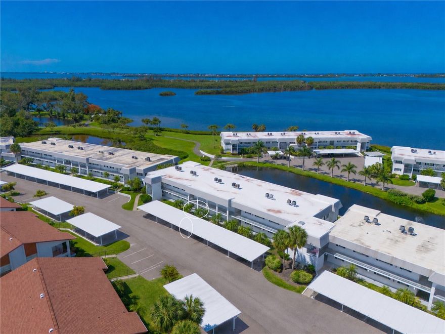FROM THE MOMENT YOU STEP INSIDE THIS FIRST-FLOOR turnkey furnished lakefront condo with glimpses of Sarasota Bay, you’ll feel the relaxed charm of Florida living. The captivating open floor plan is bright, airy, and welcoming, with spacious living and dining areas that flow effortlessly to the breezy screened lanai, creating the perfect indoor-outdoor lifestyle. Coastal-inspired colors and natural light throughout the home enhance the cheerful atmosphere and invite you to slow down, unwind, and enjoy every moment. DESIGNED WITH BOTH COMFORT AND PRIVACY in mind, the desirable split-bedroom layout makes hosting family and friends easy. Wake up to tranquil water views from the spacious primary suite, featuring a walk-in closet and an ensuite bath with a walk-in shower, new coordinating lighting and faucet. Privately located at the front of the condo is a mini-suite separated by a pocket door. The second bedroom is currently arranged as a flexible space with a trundle daybed, yet easily functions as a full-time guest bedroom, office, or hobby space. The adjacent full bath has a walk-in shower, new lighting and faucet. THIS CONDO IS OFFERED TURNKEY FURNISHED AND MOVE-IN READY allowing you to start enjoying the Florida lifestyle immediately. Whether you're searching for a full-time residence, seasonal retreat, or income-producing investment, this property offers exceptional flexibility. Use it now, rent it seasonally, or enjoy the best of both worlds until retirement. THE KITCHEN is thoughtfully designed with a breakfast bar, closet pantry, and plank flooring, making meal preparation and entertaining effortless. 
OUTDOOR LIVING TRULY SHINES on the screened lanai, where warm tropical breezes, peaceful lake views, and peeks of Sarasota Bay create a serene setting for morning coffee, evening cocktails, or simply relaxing with a good book. Pull-down shutters provide added peace of mind while you’re away. There’s even room to add patio pavers for soaking in the sunshine, enjoying views of the bayfront park, or grilling the fresh "catch of the day". CONVENIENCE AND LIFESTYLE COME TOGETHER BEAUTIFULLY in this highly sought-after Mt Vernon community. Your covered parking space and private storage unit are located just outside your door, eliminating long walks and stairs. Instead, spend your time enjoying scenic walking paths that wind along lakes, Sarasota Bay, lush tropical landscaping, and the community park, or take a short drive to the area’s stunning gulf beaches. RESIDENTS ENJOY an active and friendly community filled with amenities and surrounded by natural beauty. The maintenance-free lifestyle allows you more time to enjoy boating, beaches, dining, shopping, social activities, and everything the Florida Gulf Coast has to offer. BUILT WITH STURDY CONCRETE BLOCK construction and thoughtfully maintained over the years, this condo also features updates sprinkled throughout for comfort and peace of mind. ASSOCIATION DUES PROVIDE TREMENDOUS VALUE and cover water, sewer, trash, recycling, pest control, cable, internet, exterior maintenance & repairs, landscaping, and insurance. Mt Vernon on Sarasota Bay is known for its amenity-rich, maintenance-free lifestyle and exceptional value. 
IF YOU’VE BEEN SEARCHING for a bright coastal retreat in a picturesque waterfront community, this is the one you’ve been waiting for. Schedule your private showing today and experience firsthand what makes this home and community so special. Welcome home to paradise!