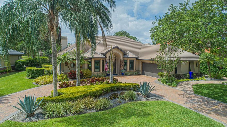 Welcome to this custom ranch-style home in Lake Nona Estates. Centrally situated on one of the quietest streets within the community, positioned halfway between the clubhouse and the front gates. This meticulously maintained home has enjoyed nearly one million dollars in upgrades. This nearly 4,000-square-foot home features four bedrooms, four baths, plus a separate office and bonus room. Polished travertine flooring accentuates the main living spaces with vaulted ceilings and retractable sliding glass doors that bring the outside in. The screen-enclosed lanai and pool deck feature a heated saltwater pool and spa, two fire pits, an outdoor bar with television, and a brand-new grill. A true entertainer's home with spectacular water views and a glimpse of the famed Lake Nona Golf Course. The spacious gourmet kitchen showcases newer KitchenAid, GE Monogram, and Bosch appliances. The elegant dining room, boasting a fireplace and a one-hundred-bottle Sub-Zero wine refrigerator and built-in bar, can easily be converted to a living room if desired. A separate bar area adjacent to the kitchen is perfect for serving drinks to your guests, equipped with a dishwasher, drawer refrigerator, and GE Monogram beverage refrigerator. The primary bedroom features a double-sided fireplace shared with the spa-like bath featuring an elegant Décor soaking tub and a walk-through shower. The rear guest bedroom enjoys French doors leading to the lanai. Whole-house generator. All new PVC plumbing. Steel casement windows. New roof was installed in 2017. Two new HVAC units. Two-car garage with extra built-in storage and an additional golf cart garage for the avid golfer.