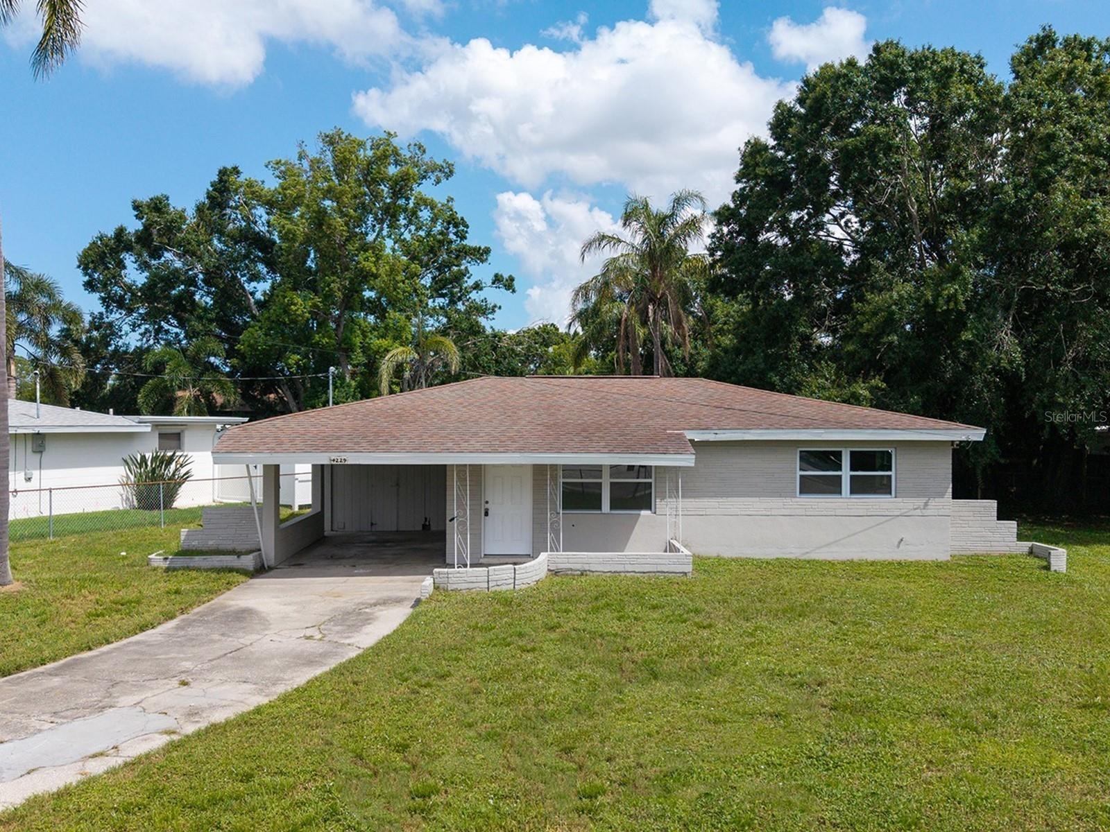 One or more photo(s) has been virtually staged. Prime Sarasota Springs Home with No Deed Restrictions and Endless Potential! This is a two-bedroom, one-bath Florida Ranch home from the 1950s. It offers an excellent investment opportunity and features new hurricane-rated windows. Situated on a spacious, fully fenced corner lot, this property is ideal for parking your boat or RV. A covered front porch leads into the main living area, and the residence boasts vintage terrazzo flooring throughout every room. The living room is connected to the eat-in kitchen and includes an additional entrance from the carport. It has a galley design with original wood cabinetry and a dinette area. The space is light and bright, with a window overlooking the backyard. The microwave, stainless steel range, and a brand-new refrigerator remain. The renovated bathroom has a tub with a modern tiled surround and built-in shower shelves. It also has a stylish vessel sink. Consider the possibility of transforming the expansive backyard into a stunning oasis by adding a sparkling pool. Imagine lounging by the water, surrounded by lush greenery and vibrant flowers. It could be the perfect retreat for relaxation and entertainment. A 1-car carport has a utility room that includes a washer/dryer, providing an additional 121 square feet of storage space. Nestled in Sarasota Springs, a dynamic community that offers the freedom and flexibility of living without the constraints of a homeowners' association (HOA), right in the heart of Sarasota! Living just moments from I-75, you’ll have a Starbucks to fuel your mornings and a top-notch gym to keep you active. Abundant shopping and dining options make every day errands a breeze. For those who love the outdoors, you’ll appreciate being close to Urfer and Colonial Oaks Parks, where you can enjoy a playground, fitness center, and tennis courts—all perfect for fun-filled weekends. And don’t forget, you’re only minutes away from the lively downtown scene and a stunning selection of local beaches. Experience the best of Sarasota living right here in Sarasota Springs!