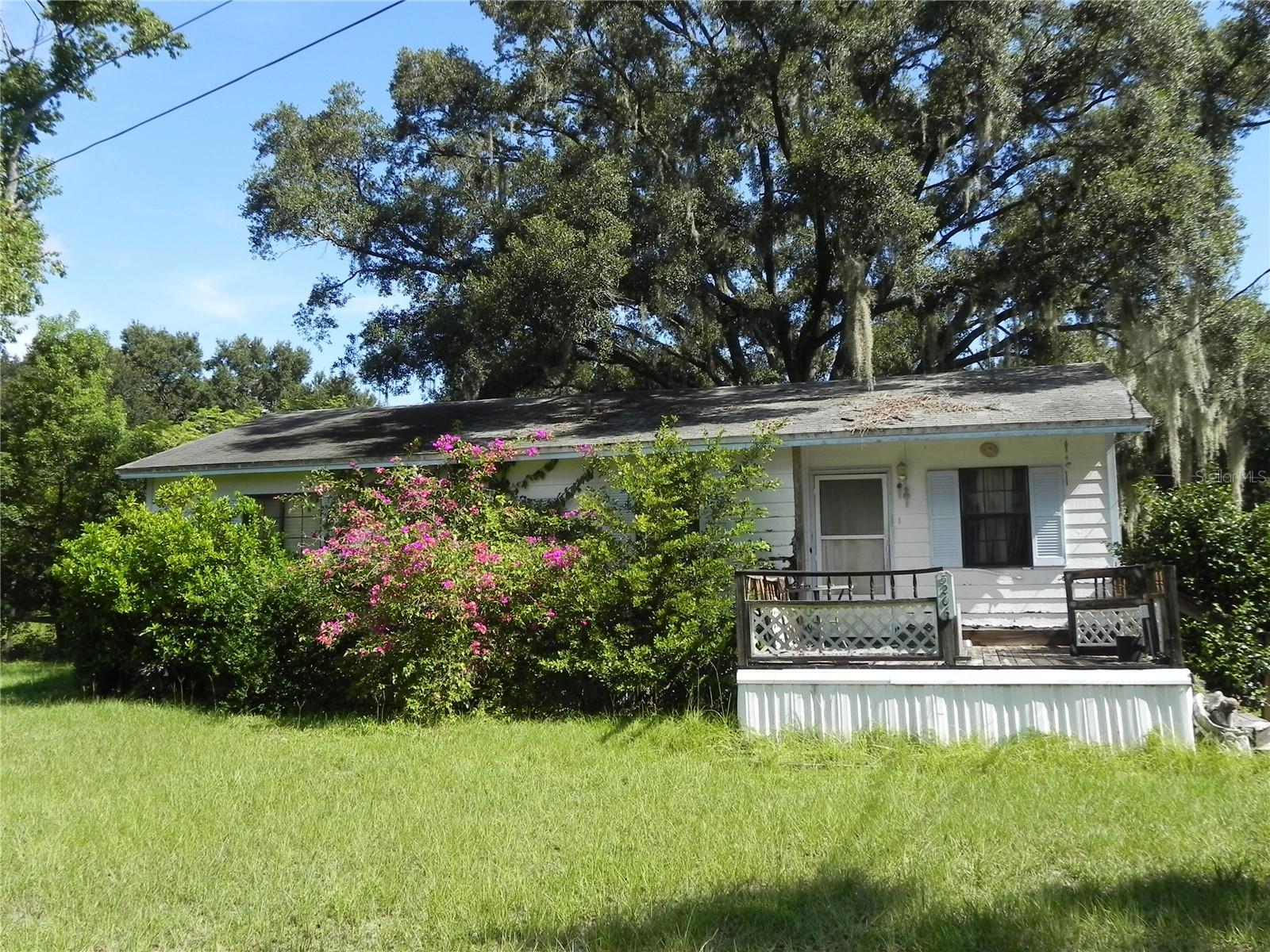 CASH ONLY. This 2br/2ba house is located just north of the Polk City Park and ball fields and is on a one acre lot. No HOA! Home is need of work but great potential. Large living room with a dinette area leading to the kitchen. Primary bedroom has walk-in closet and a tub/shower combo in the bathroom. Inside laundry room. Home is partially fenced and includes 3 sheds and a firepit. There's also a sidewalk and large concrete slab in the back of home for cook-outs and entertaining.