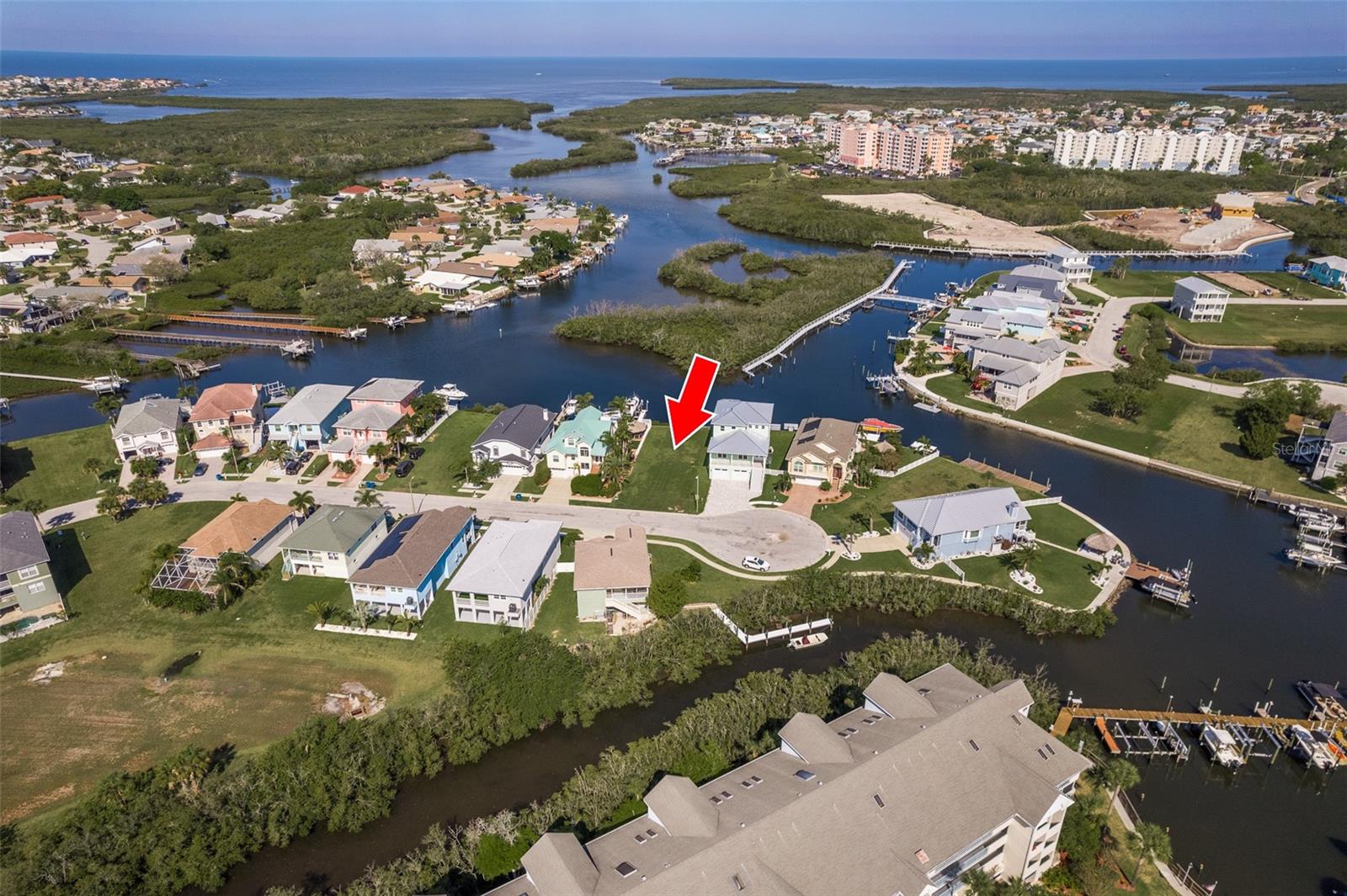 Seize the opportunity to own a rare waterfront lot featuring unobstructed, million-dollar views of the ocean! With stunning southwestern vistas and the added benefit of no rear neighbors, this property offers unparalleled privacy and the perfect setting for your dream home. Enjoy nightly sunsets that will leave you in awe! Imagine building your waterfront sanctuary with breathtaking water views from both the 2nd and 3rd floors. The nearby mangroves ensure your views remain uninterrupted by future development. This lot boasts 52 feet of water frontage, providing ample space for a pool, lush landscaping, and your own backyard oasis. With deep water access, you’re just a quick ride to Anclote Island. A floating dock is already in place; simply add a boat lift tailored to your vessel. The seawall has been recently upgraded, ensuring durability for years to come. As part of the Sea Colony at Gulf Landings community, you'll enjoy a beautifully renovated clubhouse, two private resident boat ramps (one conveniently located on Jobeth), tennis courts (including pickleball), and a heated swimming pool with a hot tub. The clubhouse is a lively center for community events and is available for private rentals. Residents also benefit from exclusive access to a private beach club, an incredible value at just $200 per year! Enjoy sandy beaches akin to Clearwater, complete with covered pavilions, restrooms, and convenient parking. Plus, the community is golf cart-friendly! Nearby, downtown New Port Richey offers vibrant activities, including Sims Park on the Cotee River with an amphitheater, walking paths, and a variety of dining options. Explore the beautiful Green Key Beach, the historic Tarpon Springs Sponge Docks, Honeymoon Island, and the lively downtown Clearwater—all just a short drive away. Easy access to Tampa, St. Petersburg, and Tampa International Airport makes this location even more desirable. The HOA permits rentals with a minimum of 30 days, three times a year. Building requirements include a minimum of 1200 SF for 2-bedroom homes or 1400 SF for 3-bedroom homes. Don’t miss your chance to build the waterfront dream home you've always envisioned and embrace the Florida beach lifestyle today! Builders are available upon request.