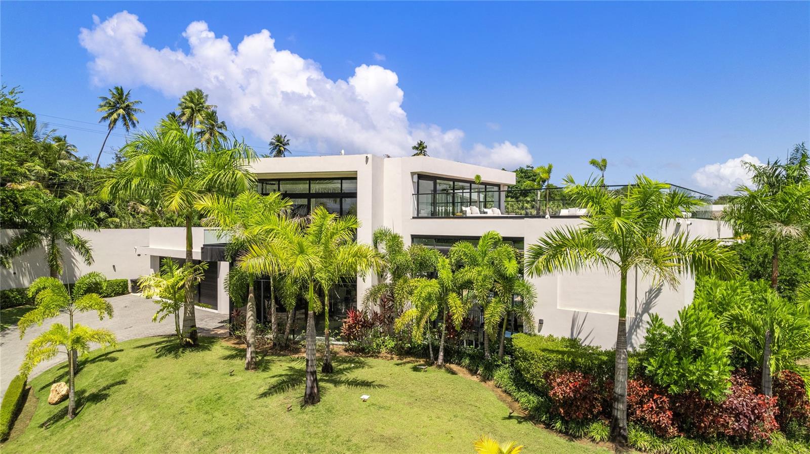 Step into a world of refined luxury with this striking open-concept, two-story estate in Dorado Country Estates, where modern elegance seamlessly blends with resort-style comfort. Set on a 2,286 square meter lot (approximately 0.56 acres) and spanning 9,562 square feet, the home is a masterclass in design and effortless indoor-outdoor living.
Inside the main residence, you'll find four spacious bedrooms, five full bathrooms, one half bath, and two flexible rooms that can be tailored to your needs—whether it's a private office, home gym, or cinema room. Every room is thoughtfully positioned around a serene central courtyard oasis, complete with a pool, jacuzzi, outdoor lounge area, and covered terrace with built-in BBQ—perfect for effortless entertaining and relaxed gatherings.
The entire second level serves as a private 2,990-square-foot retreat, featuring the expansive primary suite, a peaceful rooftop terrace, a separate living area, and an additional bedroom—an ideal penthouse-style escape. For added privacy, a detached guest casita includes two bedrooms, two bathrooms, and a fully equipped kitchenette, making it perfect for extended family or staff accommodations.
Bathed in natural light, the home is wrapped in floor-to-ceiling glass doors and windows that blur the lines between indoor comfort and outdoor beauty, highlighting a design rooted in openness and harmony. A rare opportunity, this residence is ideal for those who value exceptional architecture, ultimate privacy, and elevated living—crafted for discerning tastes and high-profile lifestyles.