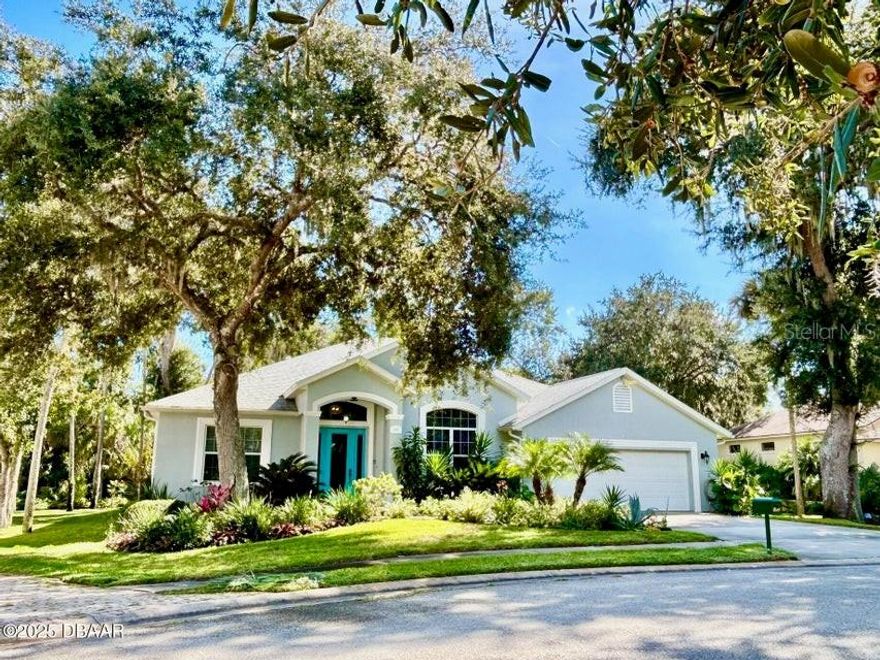 FRESH OUT OF 'HOUSE BEAUTIFUL' AND 'FINE GARDENING'!!! This gorgeous Halifax Plantation home is dually beautiful inside and out! You will fall in love with the interior designer's open floor plan, lofted ceiling, towering columns, gas fireplace, kitchen granite, new master shower tile, plus a den/office with built ins. Outdoors you will be treated to 844 sq ft of tropical lanai/screened enclosure space and a landscape design that is truly incredible! This cul-de-sac home with 3 bedrooms, 2 baths, and an enormous 708 sq ft garage back up to the 6th hole with layers of lush greenery and shrub border for privacy. A stackable 4 section sliding door opens the home to this amazing backyard botanical garden! The chef's stove, water heater, dryer and BBQ grill are propane gas powered, making an all-home generator hook-up easy. There's a well, 5 zones of sprinklers and a 50-amp outlet for a lanai hot tub. Roof 2017, A/C 2018, exterior paint 2020 and newer R-29 insulation. Community features: clubhouse, restaurant, bar, golf, pro shop, swimming and tennis. Come see this top pick for one of Ormond Beach's finest upscale home and golf communities!