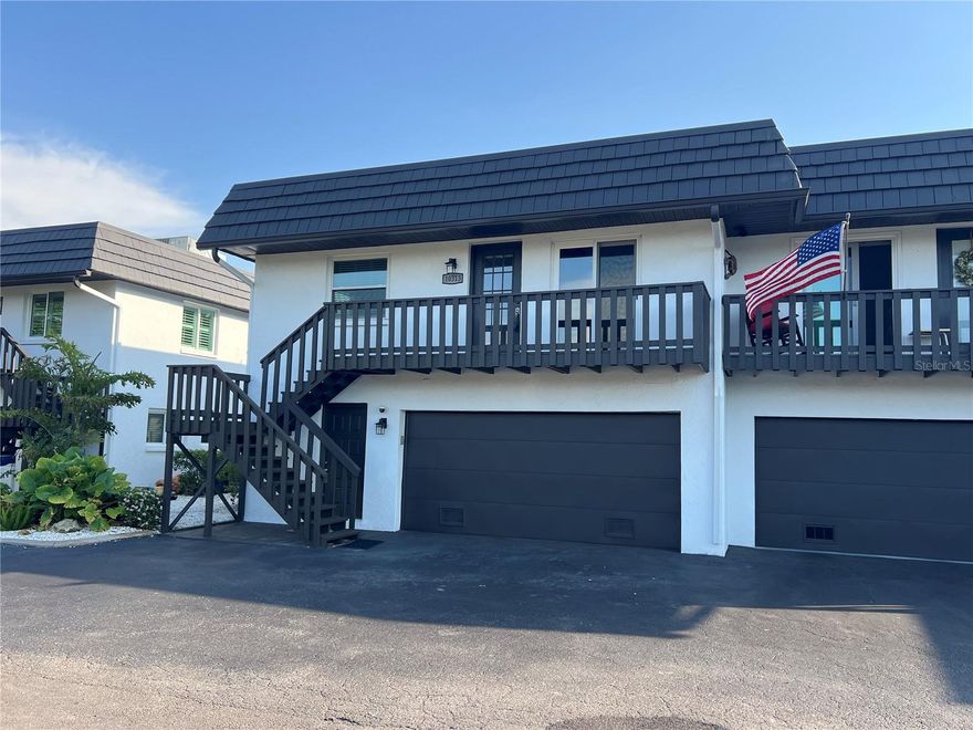 Major Price Improvement. Attention Boater and Beach Enthusiasts - Don't Let this Property Get Away!!!  Location is paramount when it comes to Florida outdoor living. This exceptional waterfront two-story condominium, with 1,728 sq. ft. under air, 2 bedrooms, 3 baths, 2 bonus rooms, family, dining and living rooms, inside laundry closet and a 2-car oversized garage, features a dock in your backyard equipped with water, electricity and a 10,000-pound capacity boat lift. The property offers direct access to Palma Sola Bay, the Intercoastal Waterway, Egmont Key, and Gulf—all minutes away—with no fixed bridges impeding navigation. Surrounded by saltwater canals, the area provides excellent opportunities for kayaking and canoeing. Nature enthusiasts will appreciate the proximity to Neal Preserve and the sandy white beaches of Anna Maria Island (AMI), located just three miles from the property. The home emphasizes maintenance-free living, presenting numerous options to enjoy the surroundings both day and night. Manatees and dolphins are frequently observed in the saltwater canal directly in front of the screened-in porches, while the sunsets create a stunning backdrop. Upon entry, shiny bamboo flooring leads you down the hallway. The well-appointed chef’s kitchen includes stainless steel appliances, an induction stove and air fryer, solid wood cabinetry, under-cabinet lighting, and expansive granite countertops. The guest bedroom and updated guest bathroom are situated to the left, with the primary bedroom offering canal views. The living and dining rooms are located straight ahead, with easy access to the downstairs area via the adjacent staircase. Impact sliding doors lead out to screened-in porches on both levels. The first-floor features durable tile flooring, storage under the stair well, Endura flood waterproof drywall, a comfortable family room, a full bathroom, and two versatile bonus rooms currently utilized as guest bedrooms. Community amenities include an oversized heated pool, tennis/pickleball court, and a basketball court. In addition, shopping, restaurants, entertainment venues, downtown Bradenton, Sarasota, Longboat Key, St. Armands, UTC Mall, and Sarasota/Bradenton Airport are all conveniently nearby. Florida Living, Sunshine, and NO State Income Tax! Possible temporary 1-0 buydown rate covered by lender. Call for details. Schedule your private showing now!