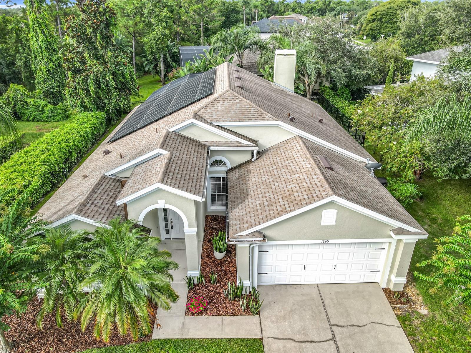 Absolutely stunning 4-bedroom, 2-bath, pool home with a 2-car garage in the highly sought-after Little Creek community of Oviedo with Solar! This 3-way split floor plan offers an open layout with soaring cathedral ceilings and abundance of natural light, creating a spacious and welcoming feel that’s perfect for entertaining. The chef’s kitchen features stainless steel appliances, marble backsplash, a walk-in pantry, and ample counter and cabinet space. Overlooking the family and dining rooms, it flows seamlessly to the pool area. The family room is anchored by a gorgeous stacked-stone fireplace that adds both style and sophistication. You’ll love the updates, including newer luxury vinyl tile throughout and 5 ¼" baseboards that give the home a fresh, modern feel. The private owner’s suite offers direct pool access, dual walk-in closets, double vanities, a garden tub, and an easy-access walk-in shower. A versatile fourth bedroom connected to the owner’s suite bath makes the perfect office, nursery, or flex space. Two additional bedrooms share a full bath on the opposite side of the home. Step outside to your private Florida oasis—lush tropical landscaping surrounds the screened pool and covered patio, offering the ideal setting for grilling, relaxing, and enjoying year-round outdoor living. Updates Include: New Roof and screen enclosure (2018), New Flooring and appliances (2021), New HVAC (2022), New Water Heater (2024), New Interior and Exterior Paint, (2025). This location is unbeatable! Within walking distance of top-rated schools, playgrounds, and Seminole State College, and just minutes to UCF, Oviedo Mall, hospitals, SR-417, and 408. You’ll also find shopping, dining, golf, nature trails, and lakes all nearby. This move-in ready pool home combines style, comfort, and convenience—don’t miss it. This is Florida living at it’s finest!