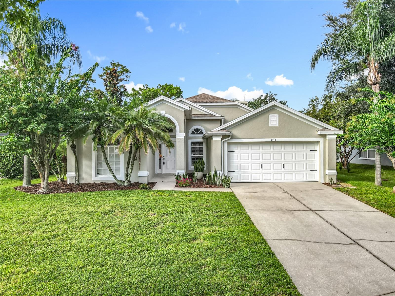 Absolutely stunning 4-bedroom, 2-bath, pool home with a 2-car garage in the highly sought-after Little Creek community of Oviedo with Solar! This 3-way split floor plan offers an open layout with soaring cathedral ceilings and abundance of natural light, creating a spacious and welcoming feel that’s perfect for entertaining. The chef’s kitchen features stainless steel appliances, marble backsplash, a walk-in pantry, and ample counter and cabinet space. Overlooking the family and dining rooms, it flows seamlessly to the pool area. The family room is anchored by a gorgeous stacked-stone fireplace that adds both style and sophistication. You’ll love the updates, including newer luxury vinyl tile throughout and 5 ¼" baseboards that give the home a fresh, modern feel. The private owner’s suite offers direct pool access, dual walk-in closets, double vanities, a garden tub, and an easy-access walk-in shower. A versatile fourth bedroom connected to the owner’s suite bath makes the perfect office, nursery, or flex space. Two additional bedrooms share a full bath on the opposite side of the home. Step outside to your private Florida oasis—lush tropical landscaping surrounds the screened pool and covered patio, offering the ideal setting for grilling, relaxing, and enjoying year-round outdoor living. Updates Include: New Roof and screen enclosure (2018), New Flooring and appliances (2021), New HVAC (2022), New Water Heater (2024), New Interior and Exterior Paint, (2025). This location is unbeatable! Within walking distance of top-rated schools, playgrounds, and Seminole State College, and just minutes to UCF, Oviedo Mall, hospitals, SR-417, and 408. You’ll also find shopping, dining, golf, nature trails, and lakes all nearby. This move-in ready pool home combines style, comfort, and convenience—don’t miss it. This is Florida living at it’s finest!