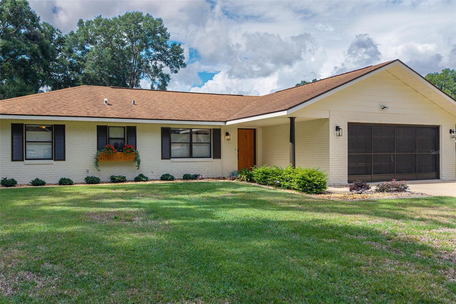 Welcome to this meticulously maintained home featuring exceptional curb appeal and thoughtful updates throughout. This inviting property offers three spacious bedrooms and two bathrooms, highlighted by elegant crown molding that adds a touch of sophistication to the living spaces. The home includes a brand new electrical panel and a two-car garage, complemented by an expansive 18' x 25' carport with a concrete slab and electric—perfect for additional vehicles or recreational use. Ample storage is provided with a 10' x 16' shed with electric, an 8' x 10' shed, and an 8' x 8' supply house, all within a fully fenced yard for privacy and security. Inside, enjoy Norman brand window treatments on every window and a custom wooden front door that enhances the home’s unique charm. Relax year-round in the bright 10’ x 20’ enclosed lanai with vinyl windows. Ideally located just minutes from the scenic Rails to Trails, this home seamlessly blends comfort, functionality, and style—ready for you to move right in!