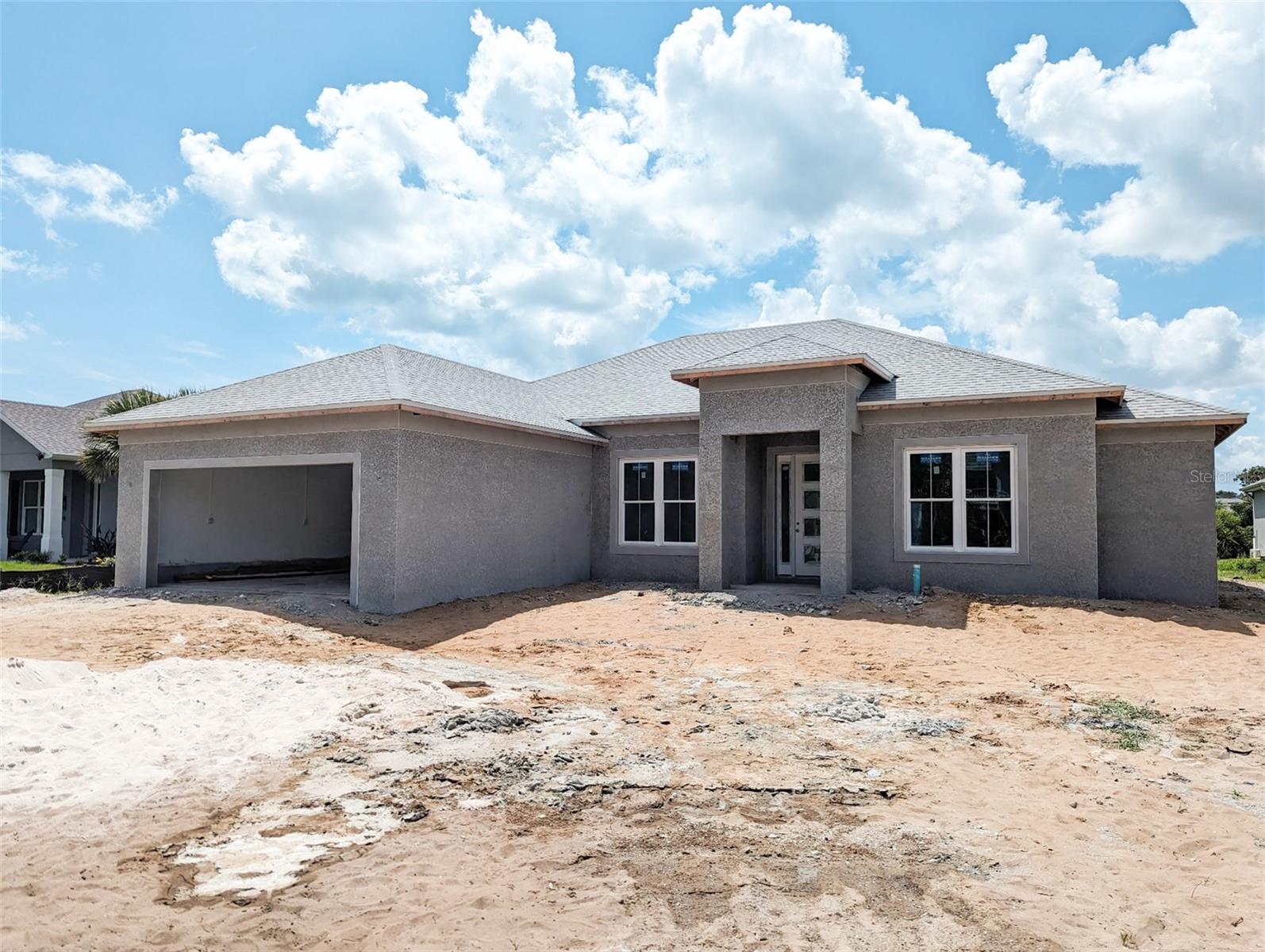Under Construction. Welcome to your brand new deeded beach access COASTAL DREAM HOME in the coveted Hammocks area. This bright and airy SUPERIOR QUALITY custom new construction home is set amidst the lulling sounds of ocean waves and majestic live oaks adding beauty and character to this charming "old Florida" slice of heaven. There is NO HOA. This STUNNING 4 bedroom 3 bath (one a cabana) OPEN CONCEPT just under 2,300sf AC plan features many upgrades including 8' designer entrance door, elevated trey ceilings, tons of NATURAL LIGHT offered by plenty of impact windows, including a wall of sliders, DECORATIVE wall accents, electric FIREPLACE, custom upgraded lighting, extensive QUARTZ, 8' kitchen island, stainless steel appliance package, tons of soft close doors and drawers cabinets with undermount lighting, beautiful WOOD-LOOK tile throughout, large master with double vanity including upgraded mirrors, separate soaking tub/shower, nice sized garage with laundry tub and sealed flooring, impressive 8' tall triple sliding glass door overlooking a HUGE rear lanai - both under roof and beyond, providing extended living and entertainment space overlooking a SPACIOUS backyard with plenty of room for a pool and more. Additional upgrades include enhanced landscaping package, IRRIGATION system and prewiring for an alarm system. Just a SHORT GOLF CART OR BIKE RIDE to a deeded access beach, near Bings Landing Park and BOAT ramps, minutes from I95, bike paths, public PICKLEBALL and tennis courts, shopping, and restaurants. Estimated completion date is October 2025. Interior photos shown here are of a similar recently completed home. ** Use builder's preferred lender and receive up to $4,000 in lender credits/closing costs.
