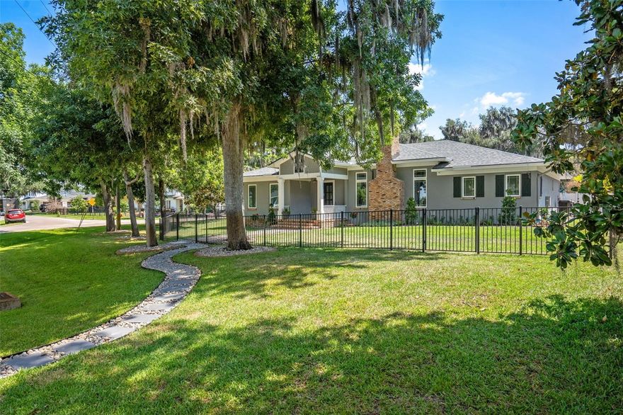 Extraordinary multigenerational living opportunity in the Town of Windermere, where mature oak trees and a quiet, established setting create a true sense of place just moments from the Butler Chain of Lakes. Set on an oversized, over half-acre corner lot in downtown Windermere, this custom home offers a rare blend of privacy, flexibility, and walkability to local dining, coffee shops, boutiques, and the weekly farmers market. Built in 2015 and thoughtfully expanded, this 5,696 square foot home features five bedrooms and five and a half bathrooms, including a fully separate casita ideal for in-law living, guests, or private quarters. From the moment you arrive, fresh landscaping and an exposed brick front porch create a warm and inviting entrance. Inside, the open living space is both spacious and comfortable, with high ceilings, wood beams, crown molding, and a gas fireplace, complemented by shiplap and exposed brick accents. The kitchen opens seamlessly to the main living area and overlooks the backyard, featuring a large Cambria quartz island, Kohler farm sink, walk-in pantry, Bosch double ovens, Viking gas cooktop, custom hood, LG refrigerator, soft-close cabinetry, under-cabinet lighting, and a dedicated coffee bar. The primary suite offers peaceful backyard views, two custom walk-in closets, and a well-appointed bath with dual vanities, a makeup station, a garden tub, and a large walk-in shower with floor-to-ceiling tile and dual showerheads. Additional bedrooms are thoughtfully placed, including one with an ensuite bath. A versatile flex room with a coffered ceiling, storage, and its own laundry setup connects to a private office with built-ins and a walk-in closet. A secondary primary suite provides a comfortable space for extended family or guests. In total, the home offers three separate laundry areas for added convenience. Outdoor living is designed for true Florida living. Two sets of sliding glass doors, including one from the flex room, open to a covered lanai with wood plank ceiling and fans, along with a fully equipped summer kitchen featuring an Artisan natural gas grill, vent hood, sink, and icemaker. The space extends to an expansive paver patio surrounding a heated saltwater pool and spa with water features, all overlooking a large fenced backyard. The casita, completed in 2023 and offering over 1,200 square feet, lives like a private residence with its own entrance and Spanish Mediterranean character, including wood beams, hardwood flooring, and a Kiva-style fireplace. It features a full living room, a kitchen with GE Café appliances and a quartz island, and a spacious bedroom suite with a custom walk-in closet and a beautifully finished bath. A screened lanai and separate fenced yard provide added privacy. A three-car garage with high ceilings includes an oversized RV-height door, 50-amp plug, and space for additional storage or lifts, along with a third laundry area. Additional features include dual AC systems, tankless water heaters, and a Generac generator. Residents of Windermere enjoy private access to the Butler Chain of Lakes, parks, tennis courts, and a boat ramp, all golf cart accessible. Golf cart friendly with tree-lined streets and a true small-town feel. No HOA and conveniently located near top-rated schools, major roadways, and world-class dining and entertainment. This is a truly unique Windermere home designed for modern multigenerational living. Schedule your private showing today!