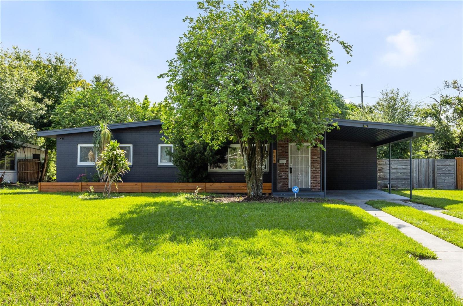 One or more photo(s) has been virtually staged. Welcome to 539 N Tampa Ave—an inviting and beautifully updated bungalow bursting with charm, thoughtful upgrades, and room to grow! This spacious 3-bedroom, 2.5-bath home sits on a generous 1/4-acre lot just minutes from the vibrant Packing District, College Park, Mills 50, and downtown Orlando, Camping World /Soccer Stadiums, and Creative Village offering unbeatable access to shops, dining, parks, and major highways.
In 2020, this home was completely gutted and professionally renovated from top to bottom. Step inside to a move-in ready interior with a fresh, modern feel. The home features an open-concept layout that seamlessly connects the living room, dining area, and kitchen—perfect for entertaining or everyday living. The kitchen includes granite countertops, a custom tile backsplash, island storage, and stainless steel appliances. Tile and laminate flooring run throughout the home, complementing the neutral color palette and natural light. Both bathrooms have been tastefully remodeled with tiled finishes, modern vanities, and sleek fixtures. Each bedroom includes ceiling fans, and a versatile bonus room—with private entrance, half bath, and separate AC—offers flexible living options for guests, work-from-home needs, or creative space. A dedicated laundry room includes a washer and dryer, and a mud room conveniently connects to the half bath for added functionality.
Step outside and enjoy the peaceful covered front porch, newly painted exterior, and a fully fenced backyard shaded by mature landscaping and five fruit trees (2 mango, avocado, and 2 starfruit). With a full 1/4 acre to enjoy, there’s plenty of space for pets, gardening, or future additions. The lot feels private and welcoming—perfect for relaxing evenings or entertaining friends.
Major systems were also replaced in 2020, including HVAC, plumbing, water heater, full electrical rewire, upgraded panel, and underground power service. The roof was replaced in 2014.
Whether you're searching for a primary residence, a rental investment, or a home with Airbnb potential, this gem checks all the boxes—location, updates, layout, land, and price. Don’t miss this opportunity to own a beautifully renovated home in one of Orlando’s most accessible and up-and-coming areas. Schedule your private showing today!