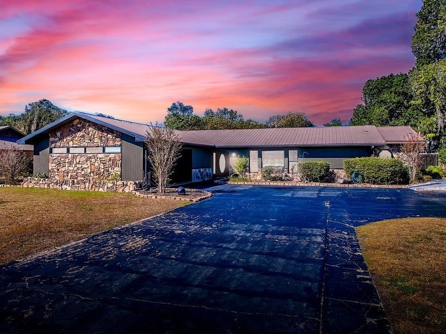 Florida living at its finest awaits you in this gorgeous pool home nestled in the sought-after waterfront community of King’s Cove in Fruitland Park! This beautiful 4-bedroom, 2-bath residence offers comfort, space, and access to Lake Griffin (Harris Chain of Lakes) via the community boat ramp, so bring your fishing poles. King's Cove, conveniently located between The Villages and Leesburg on the Lake Harris Chain of Lakes, is a desirable waterfront community with NO HOA, just a few minutes from Lake Griffin State Park, offering abundant wildlife, and you're still close to shopping, dining, and excellent schools. As you step inside, you are welcomed by abundant natural light in the spacious formal living area, ideal for gathering with family and guests. The expansive kitchen is a chef’s dream, featuring rich wood cabinetry, granite countertops, newer appliances, and ample counter space. A separate dining room provides ample space to host holidays and special occasions. The inviting family room is a true highlight, featuring an electric fireplace with charming brick accents and stunning views of the beautifully manicured landscaping and the screened-in pool area— an ideal place to relax at the end of the day. The primary suite provides a peaceful retreat with generous space and elegant details. The en-suite bathroom features a luxurious soaking tub, a separate walk-in shower, dual vanities with wood cabinetry, and ample counter space. You will also enjoy the large walk-in closet. Located on the opposite side of the home, the guest bedrooms provide comfortable accommodations for family or guests. Enjoy Florida’s year-round outdoor living from your screened-in lanai and patio, complete with a counter and sink, making it perfect for your summer kitchen. Step outside to your private oasis featuring a sparkling pool with brick accents, a decorative waterfall, and a relaxing spa. The fully fenced backyard offers plenty of space for play, and even more inviting, pull up a chair and gather around the comfortable fire pit to stargaze on beautiful evenings. In addition to the home’s versatile interior spaces, the property includes a separate shed equipped with air conditioning and electricity, offering endless possibilities, such as a man-cave, she-shed, home gym, or office, just to name a few. The garage has been converted into an additional living area, which the sellers now use as a gaming room. Recent updates include all-new ceramic tile throughout the home, refreshed bathrooms with new vanities and hardware, all-new ceiling fans, a new AC system (2022) with warranty, a new hot water heater (2022), and freshly painted interior and exterior (2023). Well-maintained and move-in-ready, this exceptional property is waiting to welcome its next family. Call today to schedule a showing! All information is deemed accurate, but must be verified by the buyer’s agent and buyer.