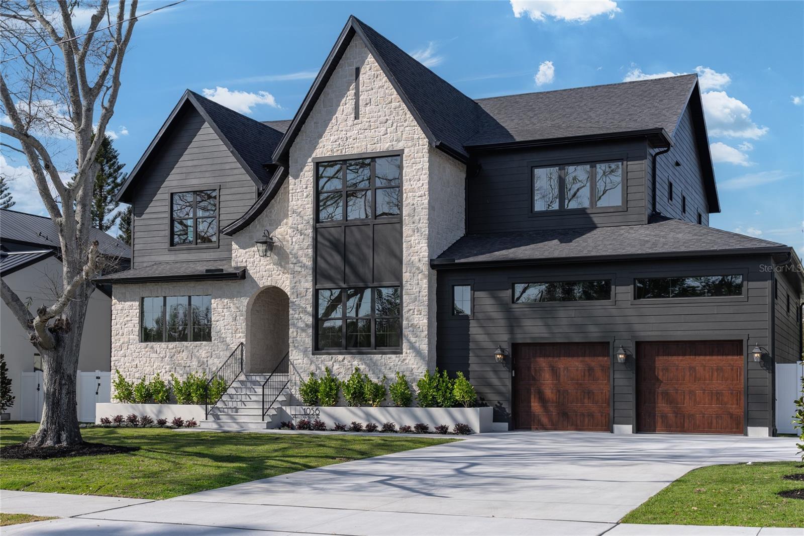 Exquisite Modern Tudor Estate in Snell Isle.
Welcome to 1056 Snell Isle Blvd NE, where timeless elegance meets modern luxury. This stunning custom-built home offers an unparalleled blend of sophistication, craftsmanship, and state-of-the-art design in one of St. Petersburg’s most coveted neighborhoods.
Step inside to soaring 26-foot vaulted ceilings in the grand living room, accentuated by custom ceiling details, built-ins, and designer cabinetry throughout. With six spacious bedrooms and 5.5 beautifully appointed baths, this home is designed for both lavish entertaining and everyday comfort.
The gourmet kitchen is a chef’s dream, featuring high end cabinetry, paneled appliances, large scullery and pantry, and a seamless flow to the expansive outdoor living space. Outside, enjoy Florida living at its finest with a custom pool and hot tub, a fully equipped outdoor kitchen, and a generous backyard—perfect for gatherings or quiet relaxation.
Built to the highest standards of safety and efficiency, this home boasts impact-rated windows and doors, energy-efficient spray foam insulation, and compliance with all current hurricane codes. A spacious three-car garage completes this extraordinary property.
Nestled in the prestigious Snell Isle community, this masterpiece offers both privacy and proximity to vibrant downtown St. Petersburg, world-class dining, and waterfront parks.
Experience a new level of luxury—schedule your private tour today.