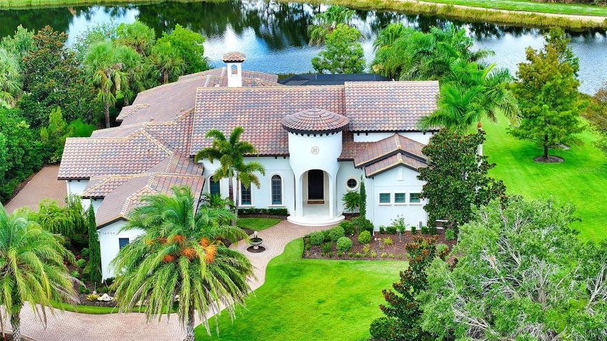 Every once in a while you come across a property that literally takes your breath away...a magical setting that feels like you just stepped into the pages of a novel...a setting that exudes tranquility and serenity.  14606 Clearlake Avenue in the Lake Club is such a residence.  As you make your way to the majestic arched wood entry door, take note of the lush landscaping beds that blanket the front entrance.  Notice the water trickling from the front entrace fountain. Step inside this nearly 4000 square foot residence and be mesmerized by the water view from every angle.  Relax in the great room with new venetian plaster feature wall and new fireplace.  The open floorplan creates multiple entertaining spaces.  The designer kitchen has quartz counters with waterfall edge, bar seating, wine refrigerator and extra storage cabinets.  Top appliances include Wolf gas cooktop, wall oven, convection microwave and Subzero refrigerator. Quartz backsplash covers the entire wall above the cabinets to the crown molding!  Kitchen opens to family room with impact glass sliders with disappearing corner!  New stone wall has built in 80" television and electric fireplace. Every seat in the gathering rooms offers water views! With ponds behind the house and to the south side, you are literally surrounded by water!  The primary wing has two walk in closets and two coat closets.  The arched door to the office is charming and inviting.  The office has a prime view of the pond and beautiful clearlake avenue bridge.  The primary bathroom is totally renovated with Kohler DVT shower and large soaking tub. Bathroom counters are a gorgeous quartzite with dual sinks and large framed mirrors.  The split floorplan has guest rooms #2 and #3 in the north east wing and share a full bath with dual sinks and bedroom #4 is located in the west wing on the northern side of the home with private bath and walk in closet.  Upgrades to thie beautifully renovated home include new AC's, Generac generator, resurfaced and retiled pool with massive spa and sunshelf, new engineered wood flooring throghout, new shellstone pavers around the pool and front entrance porch, air-conditioned garage, water softener, water filtration system, tankless hot water system and so much more!  The Lake Club in Lakewood Ranch is a premier gated community offering a gorgeous clubhouse with two spectacular pools, a state of the art gym, multiple dining options, tennis, pickleball, basketball, childrens playground and a stunning linear park with arbors, lush landscaping and beautiful trellises as you drive along Clearlake!  Even our furry freinds are cared for with their very own dog park!  Behind the gates of the Lake Club, you will find cobblestone streets, stone bridges, custom homes and mature lush landscaping.  Visit 16404 Clearlake Ave and discover the essence of Lake Club living.