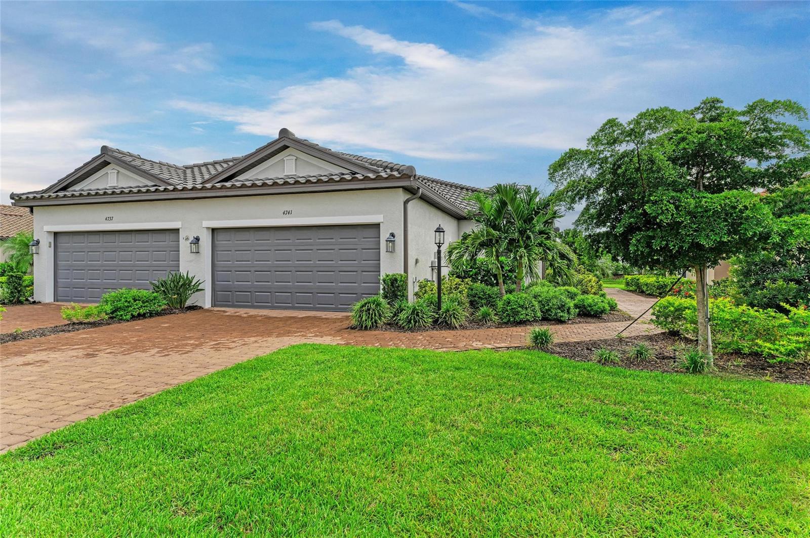 Welcome to this beautifully upgraded and meticulously maintained Ibis Twin Villa in the gated, maintenance-free community of Esplanade at Azario Lakewood Ranch—part of the nation’s #1 master-planned community. Featuring 2 bedrooms, 2 bathrooms, a versatile study/office, and a 2-car garage with a newly upgraded epoxy floor, this home sits on a premium lot offering privacy and tranquil views with no neighbors overlooking your backyard. Inside, elegant details enhance every space: four tray ceilings, 8’ interior doors, and plank tile flooring flow throughout. The gourmet kitchen shines with upgraded gray cabinetry, quartz countertops, stainless steel appliances, and a designer tile backsplash. An open-concept design connects the kitchen, dining, and great room, creating the perfect space for both everyday living and entertaining for family and friends. The primary suite, tucked at the rear of the home, provides a peaceful retreat with expansive windows, a generous walk-in closet, and a spa-inspired ensuite featuring dual sinks and a walk-in shower. At the front, a secondary bedroom with its own walk-in closet and en-suite full bath is perfect for guests. A well-designed study/office with classy pocket doors offer privacy and versatility for guests, hobbies, or a home office. The spacious laundry room is conveniently located and comes complete with an upgraded and stylish laundry/utility sink. Step through sliding doors to the screened lanai, where serene views and ample space invite you to relax, entertain, or even plan for a future pool or spa. Esplanade at Azario offers world-class amenities designed to enrich every day. Stay active with the state-of-the-art fitness center, aerobics classes, scenic walking trails, pickleball and tennis courts, and the 18-hole championship golf course. For relaxation, enjoy the heated resort-style pool, Vitality Park, fire pits, or a treatment at the full-service spa. The Culinary Center offers fine dining, wine tastings, and cooking classes, while The Venue hosts clubs and community events. Socialize at the Bahama Bar, explore Azario’s large divided large/small dog park, or simply unwind in your own backyard sanctuary with the more private satellite pool located steps away with its fire pit and grill. Conveniently located near top-rated schools, shopping, dining, and just a short drive to the Gulf Coast’s award-winning beaches, Esplanade at Azario Lakewood Ranch offers a lifestyle where every day feels like a vacation. Whether you’re seeking refined design, modern upgrades, or the perfect active Florida lifestyle, 4741 Tortona Ct delivers it all-and more!
