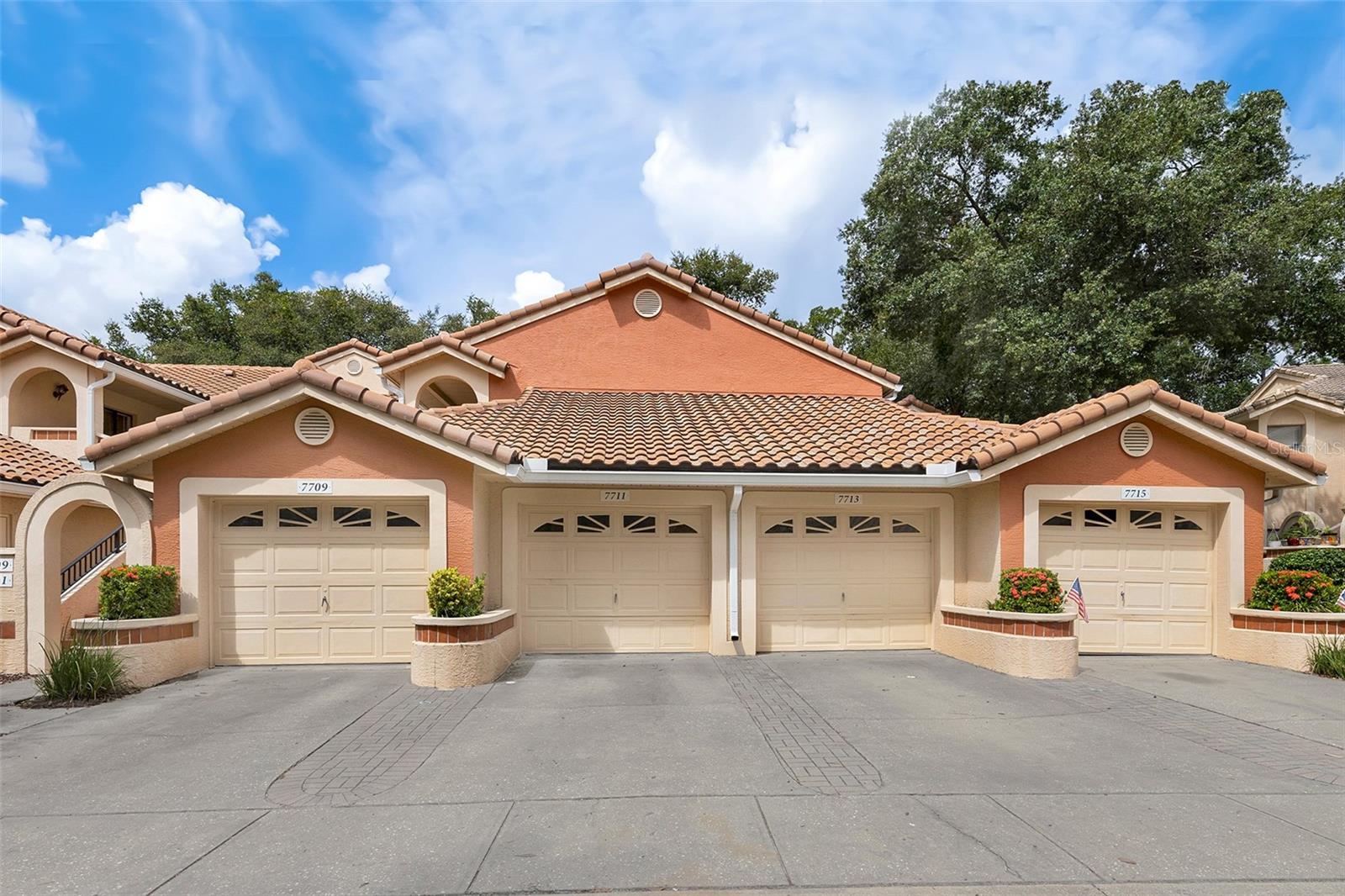 Welcome to Sanctuary at Bay Hill, a gated community in the heart of Dr. Phillips with unbeatable convenience! This single-story, ground-floor townhome offers 2 bedrooms, 2 full bathrooms, and an oversized 1-car garage with extra storage. Inside, the open layout features wood-look tile throughout the living areas and a wide-open kitchen with bright countertops, cabinetry, and backsplash, making meal prep and entertaining simple. The primary suite includes a walk-in closet, an added wardrobe for extra storage, a barn door entry to the ensuite bathroom, and a stone-tiled walk-in shower. A screened-in back porch with tiled flooring adds extra living space, while the private front courtyard creates a welcoming entry and separates the home from the garage. Community amenities include a pool, tennis courts, playground, and basketball court—all within a secure, gated neighborhood. Whether you’re looking for a low-maintenance home or a solid investment in one of Orlando’s most sought-after areas, this property is a smart choice.