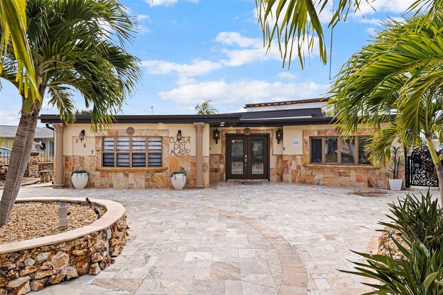 Welcome to “Casa Del Mare” – a one-of-a-kind architectural sanctuary located in the heart of Indian Rocks Beach. Step inside to discover a 3 bedroom, 2 bath residence with a thoughtful split bedroom layout, offering privacy and comfort for owners and guests alike. The interiors feature custom tile flooring, upgraded solid-core interior doors, and exquisite stonework throughout — with granite, marble, and Tavernier stone finishes used to dramatic effect.
What truly sets this home apart is its uniquely themed, fully furnished, move-in-ready design – every room curated with intention, artistry, and character. Casa Del Mare delivers an immersive coastal experience that immediately captivates guests. From sculptural stone details to bespoke décor, each space feels like stepping into a boutique resort. This is the kind of home that sparks conversation, creates instant “wow” moments, and leaves visitors absolutely stunned. The gourmet kitchen is equipped with commercial-grade appliances, gas cooking, and stone-wrapped detailing that elevates everyday living and entertaining. 
In addition to its exceptional design, “Casa Del Mare” has a proven history as a highly successful short-term rental, outperforming many comparable coastal properties in occupancy, guest satisfaction, and repeat bookings. Its layout, amenities, and resort-style atmosphere make it especially desirable for travelers seeking a luxury experience—offering the next owner both lifestyle enjoyment and top-tier income potential.  Each bath is designed as a spa retreat, featuring oversized showers with multi-shower heads, rain- and waterfall-style features, and meticulous stone craftsmanship.
Outdoors, this property truly shines. Enjoy the rooftop lounge and spa deck, resort-style pool with sun shelf, outdoor kitchen + bar, and dock with boat lift and floating dock for multiple personal watercrafts — ideal for boating, sunset cruising, or hosting during the IRB holiday boat parades.
“Casa Del Mare” is equally suited for full-time coastal living, a private retreat, or a high-performing luxury investment property. Every space has been curated to evoke relaxation, conversation, and connection — with room to gather, entertain, and create lasting memories.

This is more than a home — it’s an experience.
