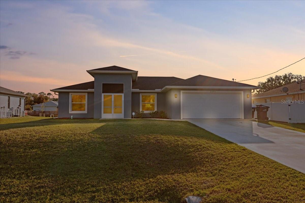 From the moment you step through the double-door entry, you're welcomed into a bright and spacious home designed for modern living. The open-concept, split floor plan immediately draws you in, with vaulted ceilings and recessed lighting enhancing the airy feel. The gourmet kitchen is a chef’s dream, featuring soft-close wood cabinets, quartz countertops, a tile backsplash, and an upgraded sink with a garbage disposal. The touchless faucet adds convenience, while the microwave’s vent fan directs air outside, keeping the space fresh. The home is also equipped with a reverse osmosis system, providing clean and purified drinking water right from the tap. The kitchen seamlessly flows into the dining and living areas, making it perfect for entertaining. The living area is the heart of the home, featuring a stunning electric fireplace positioned perfectly under your TV. With LED lighting options, you can set the ambiance for any season—whether it's a cozy winter evening or a stylish accent year-round. Just off the main living space, French doors lead to the screened lanai, where you can enjoy peaceful views of the greenbelt, providing extra privacy and space. The master suite is tucked away for tranquility, boasting a tray ceiling, a spacious walk-in closet, and an ensuite bath with dual sinks and a beautifully tiled shower. On the other side of the home, additional bedrooms and a second full bath provide comfort for family or guests. You'll also find a dedicated indoor laundry room, adding everyday convenience. Throughout the home, waterproof luxury vinyl flooring offers durability and style. Built in July 2023, this home is equipped with hurricane-impact windows for added security and energy efficiency. Plus, an additional capacitor for the air conditioning unit ensures improved performance and reliability, keeping your home cool even in the hottest months. With thoughtful upgrades and a prime location, this home is move-in ready. Schedule your showing today!