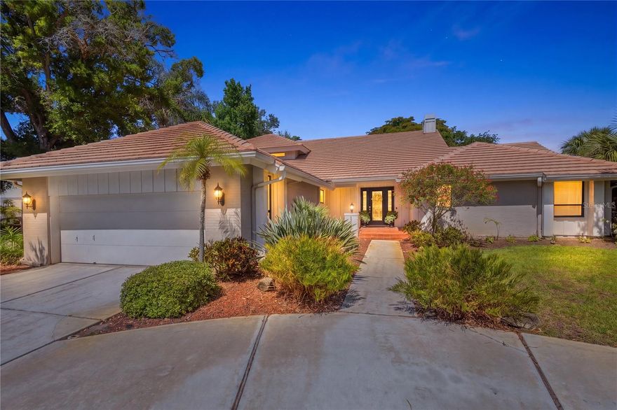 Soaring ceilings and an abundance of natural light define this spacious 4-bedroom, 4-bath residence, thoughtfully designed and custom built by the original owner for both everyday living and effortless entertaining. Rich Cypress siding, elegant crown molding, plantation shutters, and imported Italian porcelain tile add warmth, architectural refinement, and timeless style throughout the home. The open floor-plan creates a seamless flow between living spaces, while a striking floor-to-ceiling white brick wood-burning fireplace serves as a dramatic focal point in the great room. Clerestory windows and skylights enhance the bright, airy ambiance, and custom built-in cabinetry compliments the home's clean, coastal-inspired design. Step outside to a private pool with an inviting setting for relaxing or hosting guests. A flexible office/den provides the ideal space for working from home or enjoying a quiet retreat, while generously sized bedrooms ensure comfort and privacy for family and visitors alike. Located within The Landings, a highly sought-after and gated West-of-Trail community, residents enjoy a lush, park-like environment with mature landscaping, scenic walking trails, and access to the Intracoastal Waterway. Community amenities include a kayak launch, kayak racks (as available), and a fishing pier situated at the end of a scenic nature trail, perfect for embracing Sarasota's waterfront lifestyle. Optional membership to the Landings Racquet Club offers tennis courts, a fitness center, clubhouse, and a vibrant social calendar. Ideally situated just minutes from downtown Sarasota, fine dining, shopping, and the world-renowned beaches of Siesta Key, The Landings offers an exceptional blend of privacy, natural beauty, and active living.