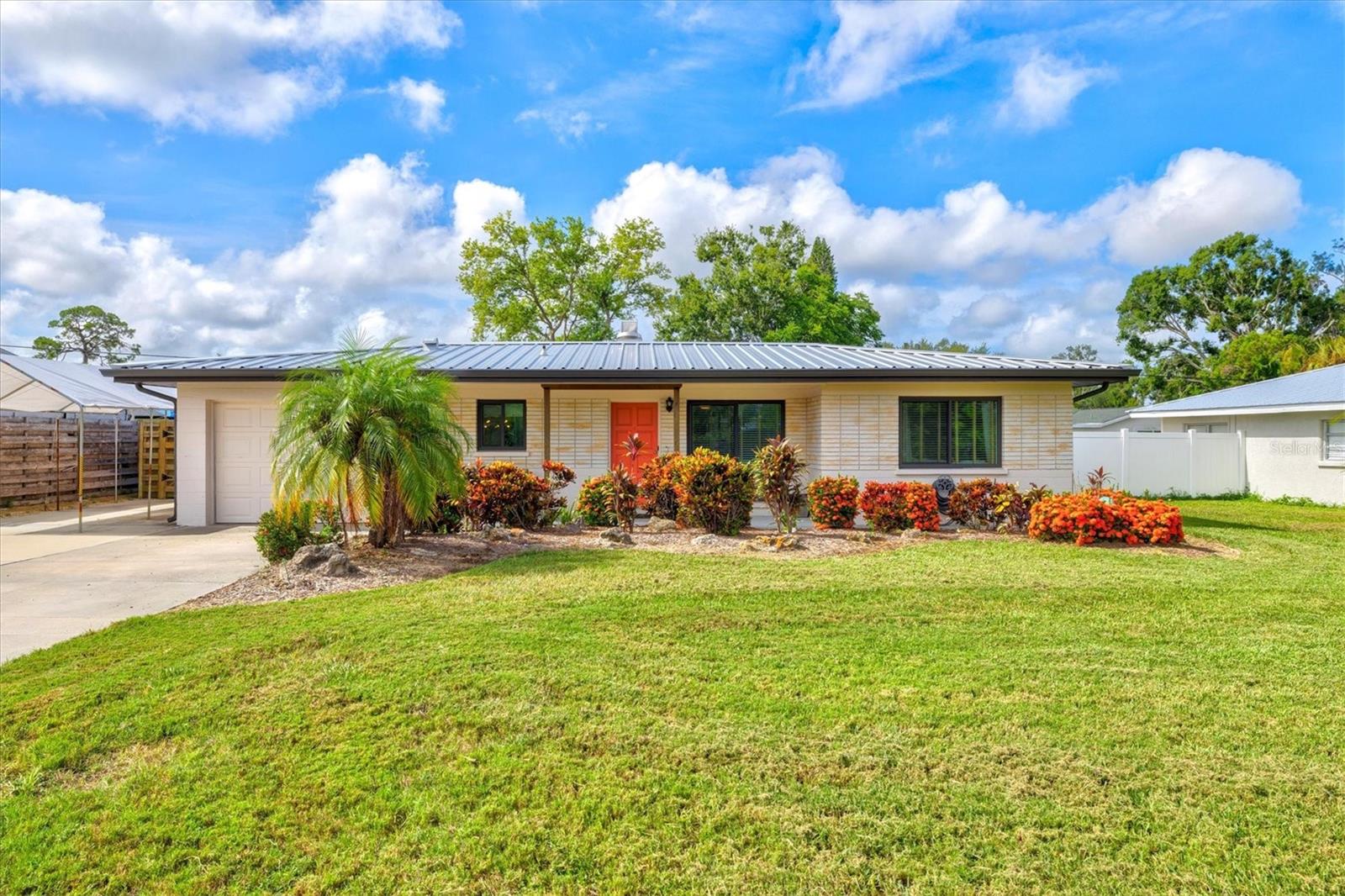 Just minutes from world-famous Siesta Key, this beautifully updated mid-century gem offers the perfect blend of style, comfort, and convenience. Step inside to find sunlit living spaces adorned with timeless Terrazzo floors, setting the tone for the home’s effortless charm. The spacious living and dining areas flow seamlessly into a sleek European-style kitchen that’s a chef’s dream—complete with high-end stainless steel appliances, including a Bosch convection oven with induction cooktop, Bosch dishwasher, quartzite countertops, designer faucet, and modern cabinetry. Enjoy morning coffee in the adjacent breakfast area before retreating to your owner’s suite, featuring customized closet shelving and an En-Suite Bath tucked behind a stylish barn door. The bath boasts a walk-in shower and quartz-topped vanity. A generously sized guest bedroom and updated guest bath with a tub/shower combo offer comfort for family or visitors. The 1-car garage with epoxy flooring provides plenty of storage with overhead racks, a workbench, and direct access to the laundry room—complete with Maytag washer and dryer, laundry sink, and even more storage. Outside, your private backyard oasis awaits with a heated saltwater pool and Travertine lanai, all within a screened enclosure. A fully fenced yard with lush landscaping, a storage shed, covered carport, and oversized driveway add to the home’s appeal. Peace of mind comes easy with recent updates, including hurricane impact windows, a metal roof with whole-house gutters (2018), A/C and water heater (2017), updated electrical (2016), and a stand-by generator with transfer switch. Located in the charming Sarasota Highlands neighborhood—near the historic Maine Colony, A-rated Riverview High School, local shopping, dining, and entertainment—you’ll also enjoy quick access to pristine beaches. With no HOA, this move-in-ready home is the perfect slice of Florida living. Schedule your showing today!