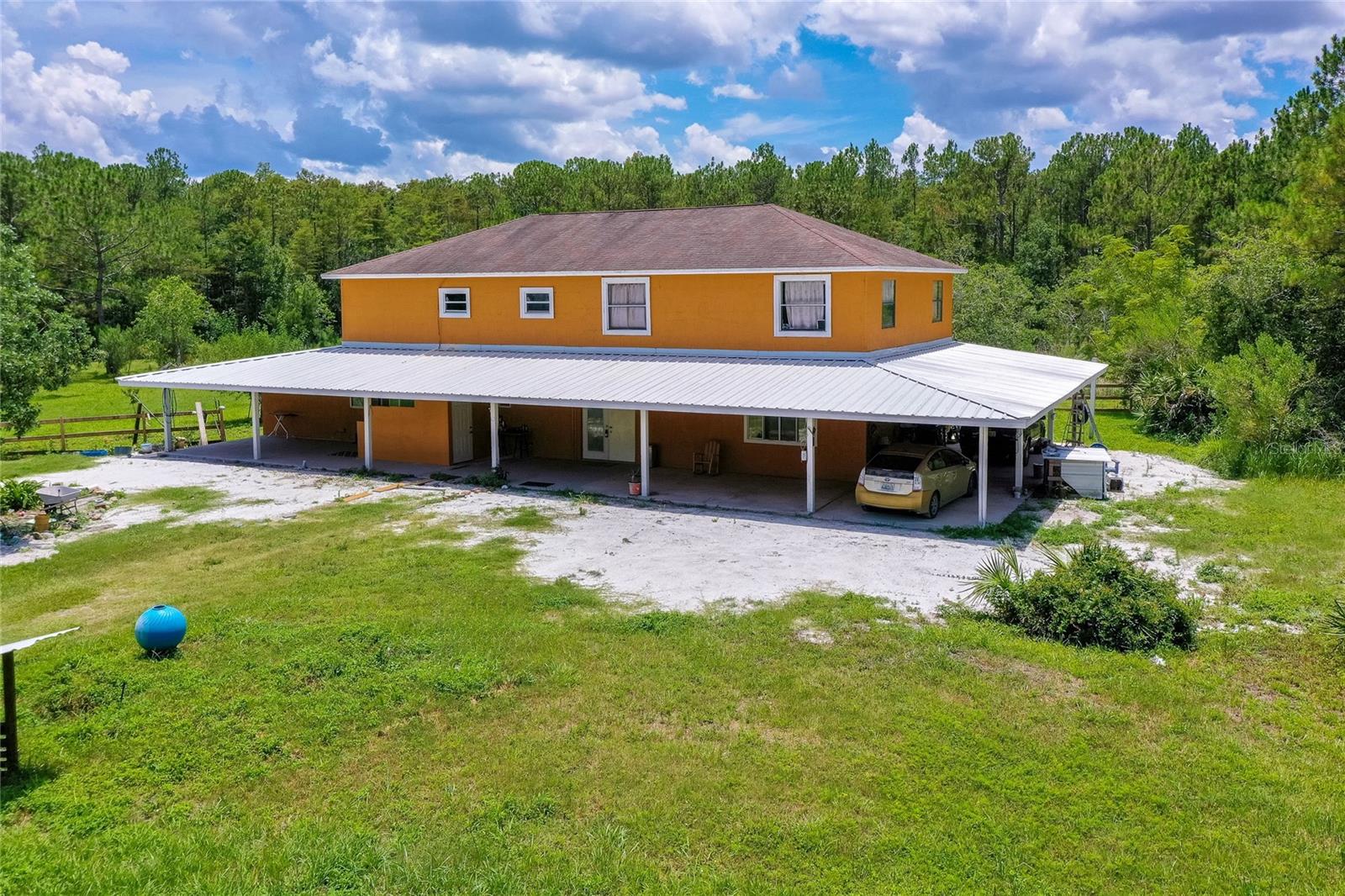 Experience the Best of Country Living! Welcome to this spacious 2-story home situated on 5 beautiful acres, offering 3,600 sq ft of comfortable living. This home features 4 bedrooms, 3 1/2 bathrooms, and a versatile flex room—perfect for a home office, gym, or guest space. The property is fenced and offers ample space for your animals, recreational vehicles, boats, work trucks, and more. There's even room to add a pool! Enjoy the expansive, remodeled kitchen, a large dining area, and generously sized living and family rooms—ideal for entertaining or relaxing with loved ones. Outdoors, you'll find a fully stocked pond with brim, bass, pike, catfish, trout, and eel. Fruit trees dot the landscape, and there's a chicken coop, aviary, and 2 horse stalls conveniently attached to the home. Whether you're seeking privacy, fresh air, or simply room to roam, this property delivers—all while being just 10 minutes from SR 44 via a private dirt road. Enjoy the perfect balance of seclusion and accessibility. You're close to I-95, I-4, New Smyrna Beach, Daytona Beach, DeLand, and Florida's beautiful beaches. Even Orlando, Jacksonville, Tampa, and the Space Coast are within reach. Don't forget about Daytona International Speedway and Daytona International Airport. Schedule your private showing today.