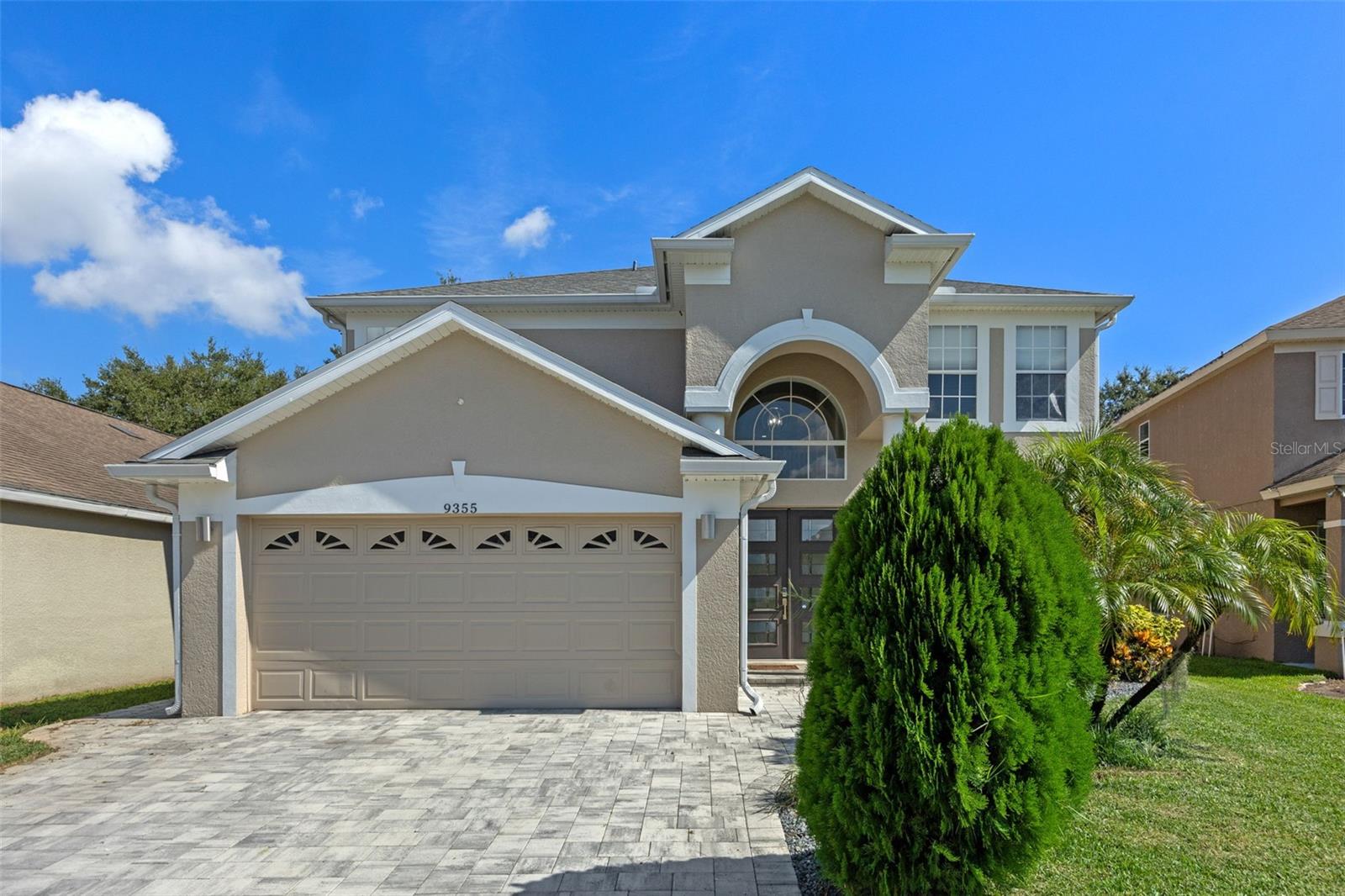 Welcome to this beautifully renovated residence in the highly desirable Lake Buena Vista area. This home has been recently remodeled from the flooring, to the roof, and everything in between - including a professionally painted interior! Gorgeous porcelain plank tile throughout the entire first floor. This dream kitchen stands as the true centerpiece offering white cabinets with crown moulding, quartz counters, glass block backsplash, all complimented by high end stainless steel appliances including a beverage cooler, built-in wall microwave and oven plus vent hood leading to the exterior. Family room has 20" vaulted ceilings along with a formal living and dining room. Master bedroom is also downstairs featuring a double sink vanity with exotic quartz counter and framed mirror. Separate shower with frameless glass door and garden tub all with ceiling to floor tile plus a huge walk in closet. Upstairs you will find 4 additional bedrooms along with a loft/bonus room plus 2 additional bathrooms equally remodeled designed with both comfort and luxury in mind to compliment the rest of the home. The spindle staircase and wood plank stairs along with extensive crown moulding in every room including bedrooms and bathrooms, plus updated lighting and plumbing fixtures make this a home you CANNOT miss. Exterior features include a new roof in 2021, professionally painted exterior, and pavers on the driveway. The screen enclosed covered Lanai overlooks the extensive brick paver backyard creating a park-like setting along with lush landscaping which is fully fenced for additional privacy.The boutique community of only 134 homes offers a private gated entry along with a playground. Location benefits include a short 10 minute drive to Disney Springs and even less to the Disney employee entrance. Easy access to I4, The Florida Turnpike, SR 429, plenty of restaurants and shopping and so much more! Schedule your showing today to experience the upgrades and design that make this home truly stand out.