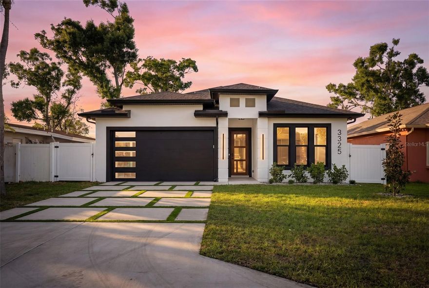 One or more photo(s) has been virtually staged. Stunning New Build! This is a Fantastic opportunity to own a Brand New Modern Solid Block Home in a centrally located neighborhood near Shops, Dining, Entertainment, Between the Gulf Beaches and Vibrant Downtown St. Pete. Beautiful Open Floor Plan. 10 Feet High Coffered Ceilings. Plenty of Natural Light in every room. Large Kitchen equipped with Brand New Stainless Steel Appliances, An Abundance of Soft Close Kitchen Cabinets Beautiful Quartz Counter Tops with an Island open to Living and Dining area. Awesome updated details from door knobs to light fixtures and Ceiling fans. Beautiful Bathrooms with shower glass enclosures and doors. Enjoy The Primary Suite with a Large walk in closet and  Bathroom with Dual Sinks, Modern Bath Tub, and Separate Glass Enclosed Shower. The Second Bedroom also offers an ensuite Bathroom.  Water resistant premium vinyl wood like floors throughout the home.  Also for your Enjoyment The Sliding Doors opens to a Covered Outdoor Kitchen followed by The backyard enclosed with a white vinyl fence large enough for entertaining, and to enjoy tranquil mornings and restful evenings. You are going to love it! Come see it for yourself and Make this your home before it is too late!