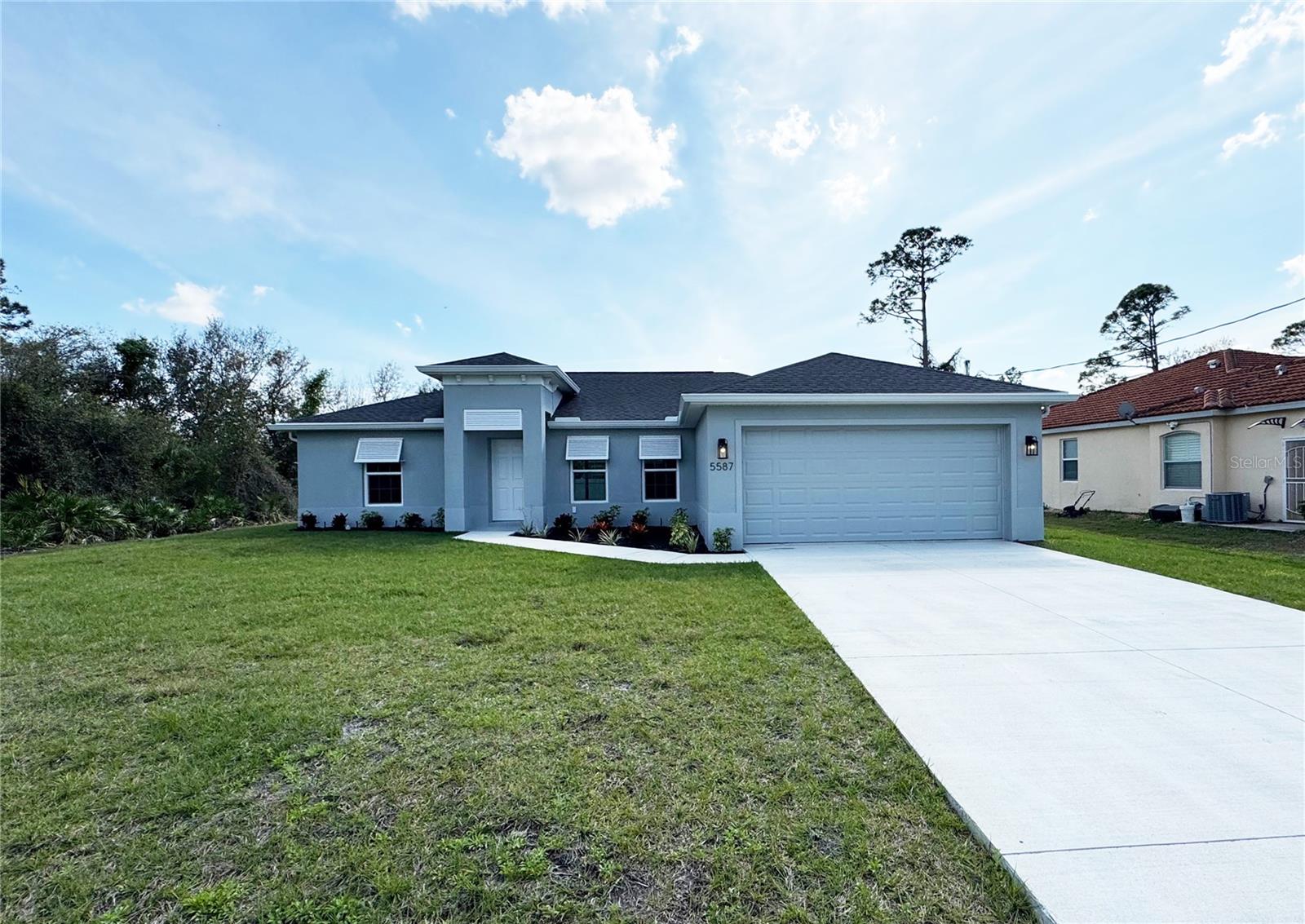 One or more photo(s) has been virtually staged. Beautiful New Construction Home Available Now on CITY WATER! Everything is Included and Everything is Upgraded! Starting with an open, split floor plan with vaulted ceilings, this home has Hurricane Impact, insulated, low e windows, full overlay cabinets, stainless steel kitchen appliances, quality stone countertops and window sills, porcelain tile throughout, 30-year shingles, 3 zone sprinkler system, screened lanai, brand name plumbing and electrical fixtures, fully sodded and landscaped. This home has been built to keep insurance, maintenance and utility costs low. Preferred lender is offering up to $1,500 in closing cost assistance! Take a tour through one of our Beautiful Homes: https://youtu.be/SFsL-Aell24