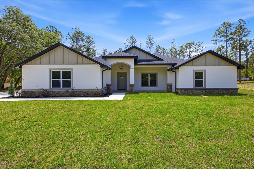 Experience the perfect blend of modern luxury and peaceful living in this newly constructed Ocala home, offering 4 bedrooms, 3 bathrooms, and over 2,200 square feet of beautifully designed living space on a stunning 1.14-acre homesite. From the moment you arrive, the covered front entry and lush landscaping set the tone for what awaits inside.
Step into a bright, open-concept floor plan highlighted by elegant tray ceilings, custom lighting, LED ceiling fans, and stylish textured walls that create a warm atmosphere. The heart of the home is the show-stopping kitchen—featuring a large prep island with a deep farmhouse sink and pot-filler faucet, sleek quartz countertops, stainless steel appliances, abundant custom cabinetry, and a convenient breakfast bar perfect for busy mornings. A dedicated dining area sits just off the kitchen, ideal for both everyday living and entertaining. The spacious primary suite is a true retreat, complete with walk-in closets, dual vanities with waterfall fixtures, and an oversized fully tiled walk-in shower with luxurious rainfall features designed to elevate your daily routine.  Enjoy Florida living at its finest on the expansive covered back patio overlooking your private backyard—perfect for relaxing or hosting guests. Additional highlights include a side-entry 2-car garage. Ideally located just minutes from shopping, dining, and everyday conveniences like Publix and Walmart, and only a short drive to the renowned World Equestrian Center, this home offers both tranquility and accessibility in one exceptional package.