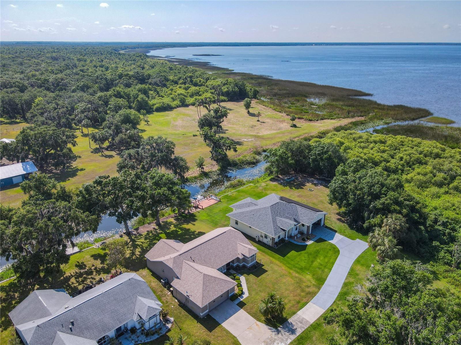 Enjoy serene waterfront living in this beautifully maintained property located in a sought-after 55+ gated community in Lake Wales, FL! Offering 3 bedrooms, 2 baths, and an oversized 2-car garage, this home provides both space and comfort in a serene, natural setting. Step inside to find a formal living room and dining room, plus a cozy dinette area off the kitchen — perfect for morning coffee or casual meals. The family room and the back screened porch invite you to relax and take in peaceful backyard views overlooking the canal that leads directly to stunning Lake Walk-In-Water. Nature lovers will appreciate the abundance of wildlife and the calming atmosphere right outside their door. Enjoy peace of mind with a new roof installed in 2023 and a new A/C system in 2022, ensuring comfort and efficiency for years to come. This active community features a clubhouse, swimming pool, tennis courts, and a fishing pier — offering plenty of opportunities to stay active, make new friends, and enjoy the Florida lifestyle. Whether you're looking for a full-time residence or a seasonal retreat, this home has everything you need for easy, relaxed living. Schedule your private showing today and discover all that this wonderful Lake Wales community has to offer!
