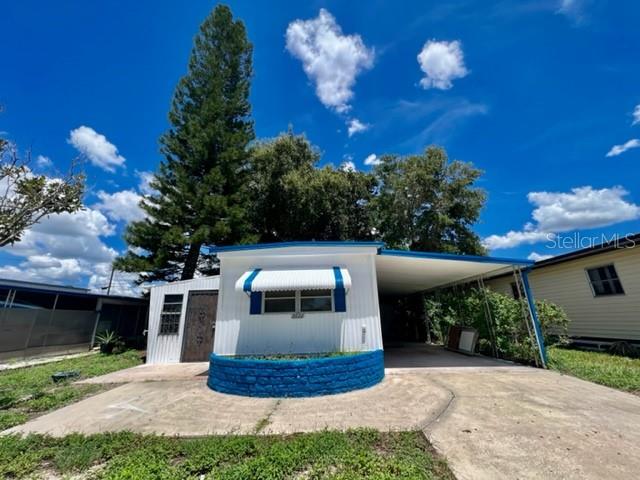 WELCOME TO YOUR SWEET HOME at 2122 Kepner Dr, Holiday, FL in the subdivision of Buena Vista. This 1966 lovely 1 bedroom + FL room + bonus room (easy 2nd bedroom), 1 bathroom UPDATED mobile home lies on a nice lot with over 4200 sqft in a NO HOA, NO CDD & NON-FLOOD ZONE. Key exterior features are covered carport parking, oversized parking pads at street level, 3 entrances into the home, rain gutters, easy-breezy landscaping & 2 storage sheds. More PHENOMENAL features are hurricane shutters for some of the windows, decorative concrete block skirting around the perimeter to prevent unwanted critters & a shaded yard to design your OUTDOOR DREAM OASIS. When you step inside, you'll LOVE the OPEN FLOOR PLAN consisting of the eat-in-kitchen, living & dining rooms, Florida & bonus rooms. This REMODELED HOME is FRESH & READY FOR THE LUCKY BUYER! The water-resistant floors are dressed with wide-plank laminate throughout the home for fluidity of design. The kitchen features a stainless steel double sink, plentiful cabinets with handles, expansive ceramic-tiled counters & appliances including a smooth-top glass range, range vent & fridge. NATURAL SUNSHINE streams inside through the multiple windows ILLUMINATING the interior together with light fixtures. The primary bedroom can fit queen-size furniture & has a fan & LOTS OF CLOSETS - 2 closets with barn-style, sliding doors on either side of the built-in desk & another wall of closet. The generous-sized bathroom features dresser-vanity, STONE bowl sink, MODERN faucet & tub/shower combo. The laundry hookups are also found in the bathroom. The Florida room can be set up as a casual dining space or office while the bonus room can EASILY be a 2nd bedroom. Your new home is cooled/heated with 3 window AC units found in the living room, primary bedroom & bonus room. There are 2 closets in the hall for additional storage & of course, there are the 2 detached shed on the property too. Your new home is PERFECT as a primary residence, investment property or vacation getaway. Location is IDEAL near beaches, shopping, restaurants, medical plazas, places of worship & tourist attractions. MAKE THIS YOUR FUTURE HOME!