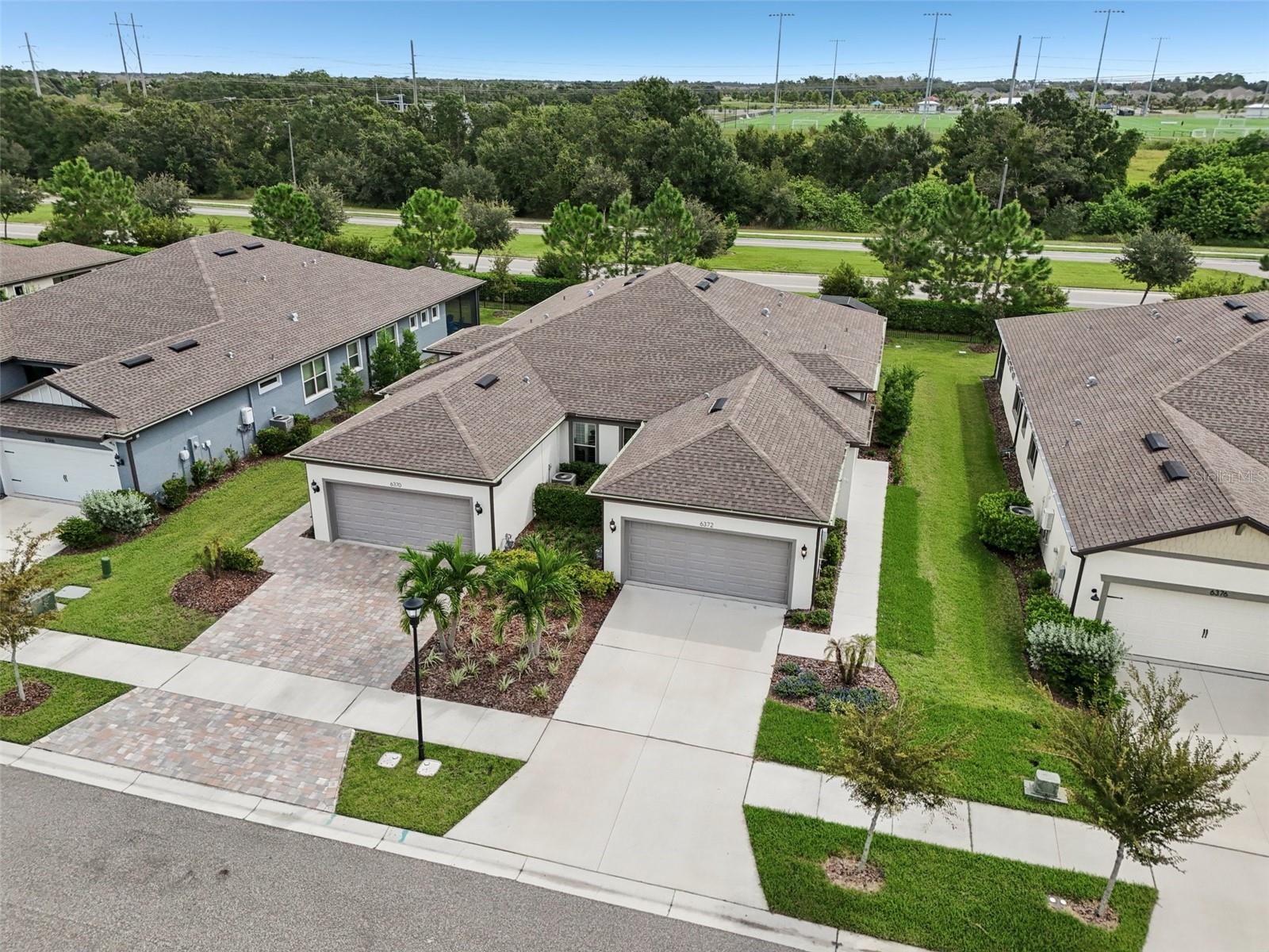 Welcome to Waterset, where style meets convenience! This beautifully designed 2BR/2BA villa with den (1,543 sq. ft., built 2021) features an inviting private entry, open layout, and tasteful finishes throughout. Enjoy luxury vinyl plank flooring, a gourmet kitchen with quartz countertops, stainless appliances, gas range, and glass-tile backsplash. The den with French doors is perfect for an office or flex space, while triple sliders lead to a peaceful screened lanai. HOA includes lawn care, irrigation, and pest control, allowing more time to enjoy Waterset’s resort-style amenities—pools, fitness centers, clubhouse, trails, sports courts, café, dog park & more. Ideally located in Apollo Beach, just minutes to beaches, shopping, dining, and the VA hospital. Make your appointment today as this gem is priced to sell!