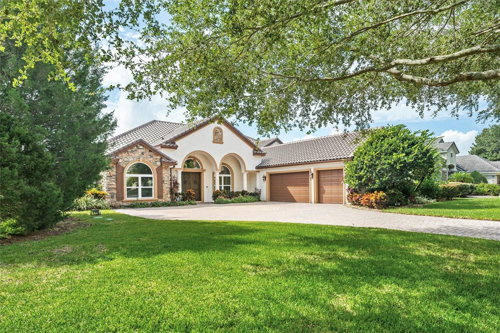 Discover refined luxury in the guard-gated Tildens Grove community. This custom-built, traditional-style residence spans approximately 5,300 sqft across a prime .64 acre lot backing to a serene conservation pond. Boasting 6 bedrooms and 4½ baths, the home offers exceptional craftsmanship and thoughtful updates throughout. The gourmet kitchen is a chef’s dream—featuring a large center island, custom cabinetry, walk-in pantry, gas cooktop, double ovens, wine cellar, bar area, and a dedicated office nook. Adjacent, the family room with a gas fireplace flows seamlessly to an outdoor oasis—complete with a covered lanai, summer kitchen, wood burning stone
fireplace, saltwater heated beach entry pool, hot tub, and putting green—perfect for year round entertaining Retreat to the luxurious main floor primary suite with double tray ceiling, crown molding, and a sitting area overlooking the pool. A versatile second bedroom offers a private entrance, full bath, and pool access—ideal as an in-law or guest suite. Upstairs, find a bonus room, sixth bedroom, and additional full bath—offering privacy and space for family or guests. Additional highlights include a 3-car garage, expansive outdoor entertaining space, pond views, high ceilings, crown moldings, and a thoughtful floor plan combining elegance and comfort. Located just minutes from fine dining, premier shopping, downtown Windermere, and area theme parks, this exceptional property offers resort-style living in one of Windermere’s most desirable enclaves.