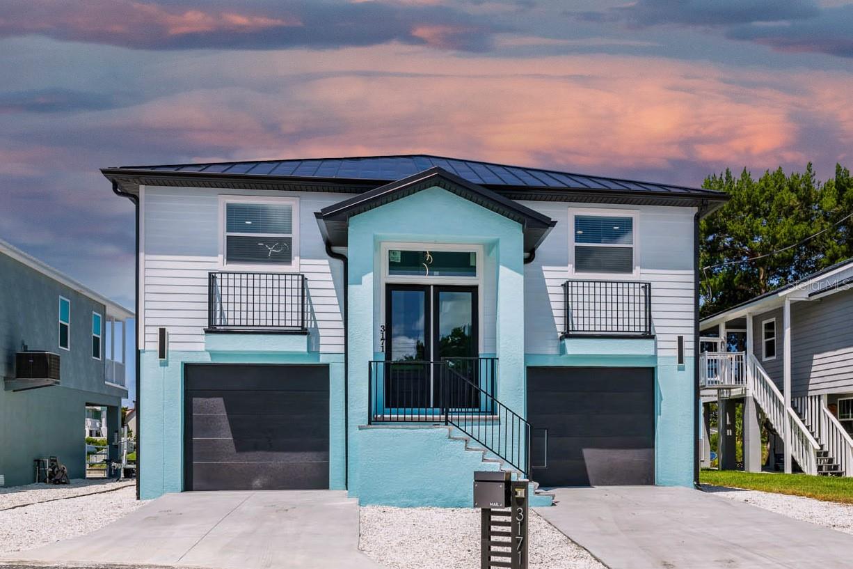 MOVE IN READY, NEW CONSTRUCTION HOME WITH STUNNING WEST-FACING WATER VIEWS & BUILDER WARRANTY!
Experience the perfect blend of coastal charm and modern elegance in this open-concept 3 bedroom, 2 bath split floor plan home designed for the waterfront lifestyle. Every detail has been thoughtfully upgraded—from luxury vinyl plank floors, impact windows and doors, quartz countertops with a waterfall island, crown moulding, durable Hardie board siding and 26 GA standing steam metal roof.
The gourmet kitchen is a showstopper, featuring stainless steel smart appliances, an electric range with hood vent, built-in double oven/microwave, ceiling-height cabinetry, an eat-in island with wine fridge, and gorgeous quartz surfaces. The kitchen flows seamlessly into the bright living room with slider access to the balcony, while the front room serves as a dining area or easily converts to a flex space.
The primary suite offers his-and-hers closets, private porch access, and an en-suite bath with a double vanity, backlit mirror, and a glass-enclosed shower. Two oversized guest bedrooms share a stylish bath with a tub/shower combo, raised sink vanity, and light-up mirror.
An interior staircase leads to the expansive first level, providing parking for 4+ vehicles, a game room, workshop, or endless possibilities—enhanced by large windows and dual sliders for abundant natural light.
Outside, the spacious backyard offers plenty of room for a future pool, features a tall seawall with paver cap, and is xeriscaped for low maintenance. Estimated homeowner's insurance for owner-occupants is just 1,241 dollars per year thanks to its new construction status.
Hernando Beach is a vibrant waterfront community that offers the best of coastal living—boating, kayaking, paddleboarding, fishing, and more. Just minutes from the world-famous Weeki Wachee Springs, residents also enjoy close proximity to shopping, dining, and hospitals. The community is golf cart friendly and allows short-term rentals with no HOA, no deed restrictions, making it perfect for full-time residents, part-time snowbirds, or investors. The Suncoast Parkway offers easy commuting to Tampa, Brooksville, and beyond. This is your chance to own a piece of paradise with unlimited potential and jaw-dropping views.
Schedule your showing today, move in, relax, and enjoy breathtaking Gulf sunsets right from your own porch!