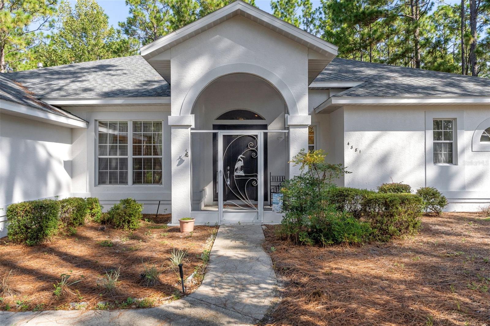 PINE RIDGE ESTATES - 3-bedroom, with 4th bedroom or bonus room, 3.5-baths and office with 2,609 sq. ft. of comfortable living space, nestled on nearly 1.5 acres with pool.
The heart of the home is the kitchen, complete with a large island, large walk-in pantry with an extra gas range perfect for holiday dinners—built-in shelving, freezer, plus washer and dryer. The spacious primary suite offers a relaxing retreat with a walk-in closet, dual sinks, soaking tub, and separate shower.
An oversized bonus room provides endless possibilities—use it as a 4th bedroom, home office, gym, or craft space. The home’s thoughtful layout is designed for versatility and everyday living.
Step outside to your own private oasis—a sparkling pool, solar heated with a covered lanai overlooking the serene backyard, where you can relax and enjoy nature at its best. NEW ROOF IN 2021 AND NEW A/C IN 2018. FRESHLY PAINTED ON THE EXTERIOR. This home is spacious and built for family and entertaining. The interior needs some cosmetic improvements, such as painting and flooring. Surrounded by beautiful homes, this may be where you will want to call home as well.
With a 2-car garage and plenty of usable space, this home is ready to meet all your lifestyle needs.