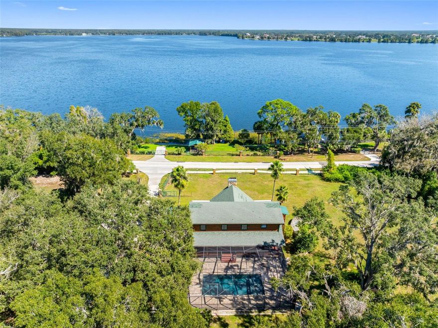 Welcome to your lakeside legend on Lake Thonotosassa, the largest natural lake in Hillsborough County, spanning more than 819 acres of sparkling freshwater beauty. This nearly 2.5-acre private estate is a handcrafted log-cabin masterpiece, surrounded by multi-million-dollar homes yet offering unmatched freedom and privacy. Inside, you’ll find six bedrooms and five baths, soaring vaulted ceilings, and walls of hand-finished wood that glow with natural warmth and timeless craftsmanship. A newly added full kitchen on the first floor creates flexibility, ideal for multi-generational living, private guest quarters, or a short-term rental setup with no HOA and no rental restrictions. The pool area was completely remodeled and lifted, adding a new sun shelf and a secure retaining wall for long-term stability. A second, separate planter retaining wall was installed previously, paired with an underground drainage system that keeps the property pristine and ideally graded. Though the pool sits privately to the rear, you’ll enjoy lake views from every front window, balcony and porch, as sunrise and sunsets over the water never gets old. A waterfall and stream flow gracefully alongside the home, leading to a tranquil Koi pond that completes the peaceful, resort-style ambiance. Across the street on your private lakefront parcel, a cabana with fire pit and outdoor kitchen sets the stage for unforgettable gatherings. The estate is self-sustained with a septic system and new water purification setup, meaning no water or sewer bills. Inside, treat yourself and your guests to the enormous, elegant Turkish bath, a luxurious retreat worthy of a boutique spa. A three-car detached garage shelters your adult-toy investments such as boats, bikes and jet skis, while 10-plus parking spaces between the garage, pads and custom carport ensure room for every guest. Just minutes from USF, top-tier medical centers, Tampa International Airport and Tampa Stadium, you’ll have the most modern conveniences within easy reach yet feel like you’re living in the quiet country, surrounded by water, wildlife and wide-open skies. Every detail of this property blends artistry with utility, luxury with freedom and comfort with opportunity, all set on the shimmering shores of Lake Thonotosassa, where Florida living feels wild, warm and wonderfully alive.