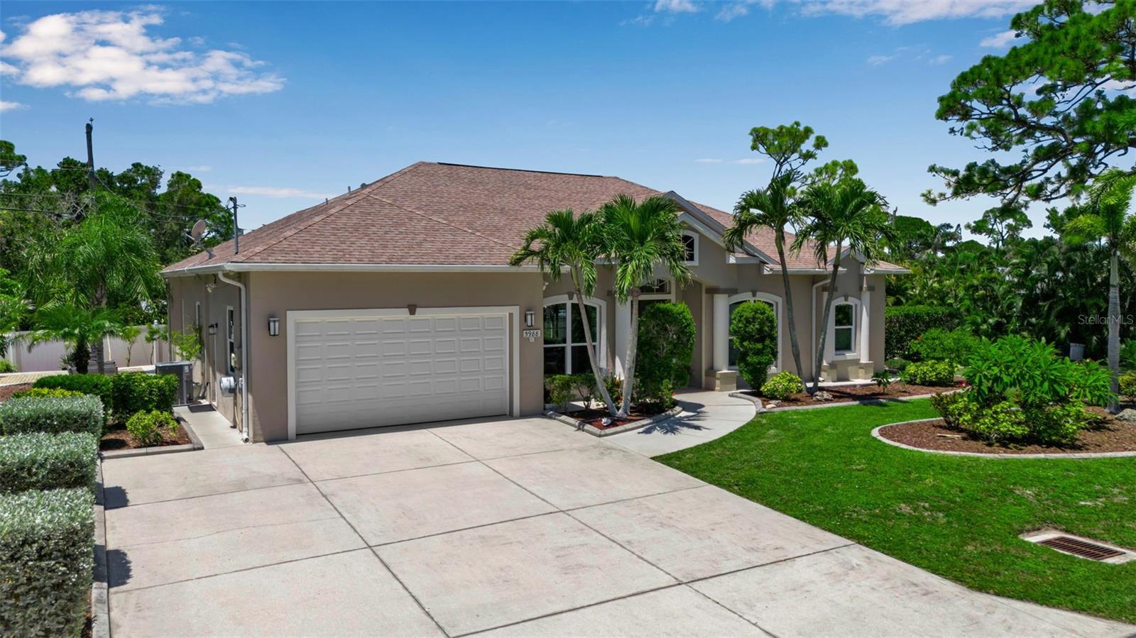 Welcome to this meticulously maintained, custom-built, and recently updated 2,426 sq. ft. home in beautiful Venice, Florida — just 1.5 miles from the Gulf beaches and minutes from charming shops, dining, and recreation. Offering 4 bedrooms and 2 full bathrooms, this home is perfect as a primary residence or a vacation getaway. Enjoy your double lot with lush landscaping and the convenience of having city water and sewer (connected in 2018). From the moment you arrive, you’ll be impressed by the curb appeal — an oversized driveway, fruit trees, rose gardens, and walking paths around the home, all framed by a stately double 8’ front entry door with antique glass, protected by a hurricane-rated screen and portico. Step inside and you’re welcomed by soaring 12’ ceilings in the main living areas, 11’ ceilings in the rest of the home, extensive crown molding, double tray ceilings, and architectural details throughout. Natural light pours in from 17 large PGT hurricane-impact windows, while sound-barrier insulated walls keep the space quiet and serene. The open floor plan flows seamlessly into the gourmet kitchen, recently remodeled with expanded quartz countertops, reconditioned 42” custom cabinets, a stylish backsplash, and all new stainless steel and glass appliances including refrigerator, oven/range, microwave, washer, and dryer. A breakfast nook offers casual dining, while a bar-height counter creates the perfect gathering spot. The split bedroom layout features four bedrooms with three featuring cozy carpeting and one versatile bedroom/den finished with easy-care laminate flooring while 18" porcelain tile on the diagonal enhances the main living areas and bathrooms. One of the guest bathrooms also include a smart bidet toilet that adds an extra touch of modern luxury. The spacious primary suite has direct access to the lanai through 8’ high sliders and features a fully remodeled spa-style bathroom with an oversized glass-enclosed shower clad in Brazilian granite, a soaking tub, new vanities and cabinets, upgraded tile flooring, and two walk-in closets. Outdoor living is at its best here, with an expansive lanai featuring an automated 23.5’ x 11’ screen for shade and comfort. Unwind in the Hot Springs Vanguard 6-person remote-controlled hot tub/spa with a new cover, or enjoy the peaceful backyard with privacy fencing, landscaped seating areas, and a well-maintained storage shed. The home is built for peace of mind with hurricane-rated features, including impact windows, a hurricane-mitigated garage door, and a hurricane-rated screen system. Additional upgrades include a high-capacity 5-ton AC system with warranty until 2035, a reconditioned roof with warranty through 2029, and a Ring security system with five hardwired cameras/lights. Located in one of Venice’s most desirable areas, you’re just minutes from Venice Beach, Historic Downtown Venice, fishing piers, boating, golf courses, and scenic parks. Only two blocks away, you’ll find the South Lemon Bay Preserve, perfect for nature walks and outdoor enjoyment, while the nearby public boat launch at Manasota Beach makes days on the water a breeze. Top-rated Sarasota County schools, medical facilities, shopping, and dining are all close by, making daily life convenient and enjoyable. With every upgrade already complete and a location that offers both coastal charm and everyday convenience, 5988 Viola Road delivers the lifestyle, comfort, and quality you’ve been searching for.