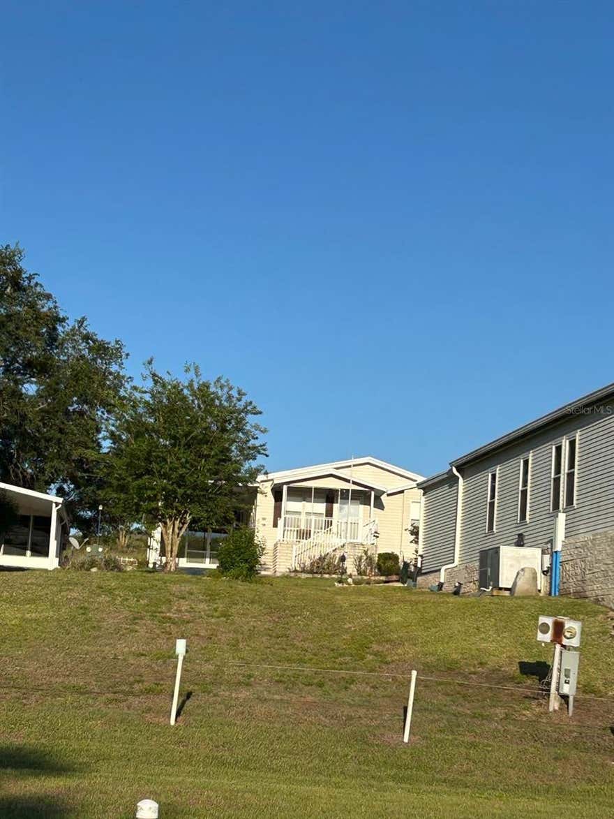 Rare opportunity to custom-build your Florida retirement on this beautifully elevated, 0.11-acre lot in the highly sought-after 55+ community of Twin Fountains. Positioned with no rear neighbors, this homesite offers a level of privacy and a natural breeze that is hard to find. Whether you’re looking to place a brand-new manufactured home or a gently used model (up to 3 years old), this lot is perfectly prepped and ready for a single or double-wide layout. Enjoy a low-maintenance lifestyle where your $180/month HOA covers lawn care, cable, internet, water, and sewer. Spend your days at the heated community pool or exploring the central Florida coastlines—both just 90 minutes away. Owner financing is available, making it easier than ever to secure your piece of paradise.