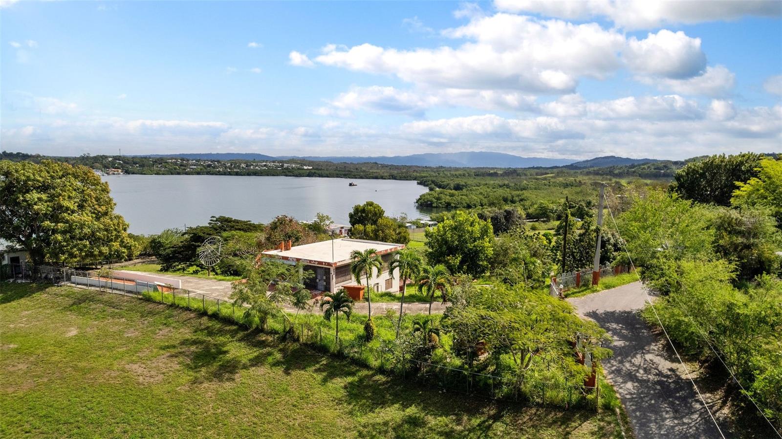 Located in Cabo Rojo, this prime lot is poised to benefit from the influx of world-class luxury projects transforming the region. With zoning for residential and potential tourism-related development, it presents a diverse array of opportunities for high-end construction. Positioned in an area experiencing significant upscale growth, this property ensures long-term appreciation. The increasing demand for exclusive waterfront real estate makes it a highly attractive investment option.
Enhancing its value, the property includes a sturdy concrete structure accompanied by architectural plans for renovation and expansion, all included in the sale. This feature provides a unique advantage, allowing buyers to expedite development while maximizing the potential of the existing foundation. More than just a plot of land, this is an opportunity to claim a piece of Cabo Rojo’s evolving luxury landscape and secure an extraordinary coastal investment.
The property is just minutes from Club Deportivo, a premier social and sports venue featuring an 18-hole golf course, tennis and pickleball courts, a marina, swimming pool, and a private clubhouse with fine dining and social events. This coastal gem provides direct bay views and is just 10 minutes from the Cabo Rojo Marina, making it an ideal retreat for boating enthusiasts.
The property is within easy reach of the most pristine beaches on the West Coast, including Buyé, Combate, and Playa Sucia, while also being immersed in the celebrated coastal and culinary culture that attracts both locals and international visitors. Just minutes from acclaimed restaurants, outdoor adventures, and eco-tourism attractions, this land also benefits from convenient access to major highways and key points of interest.